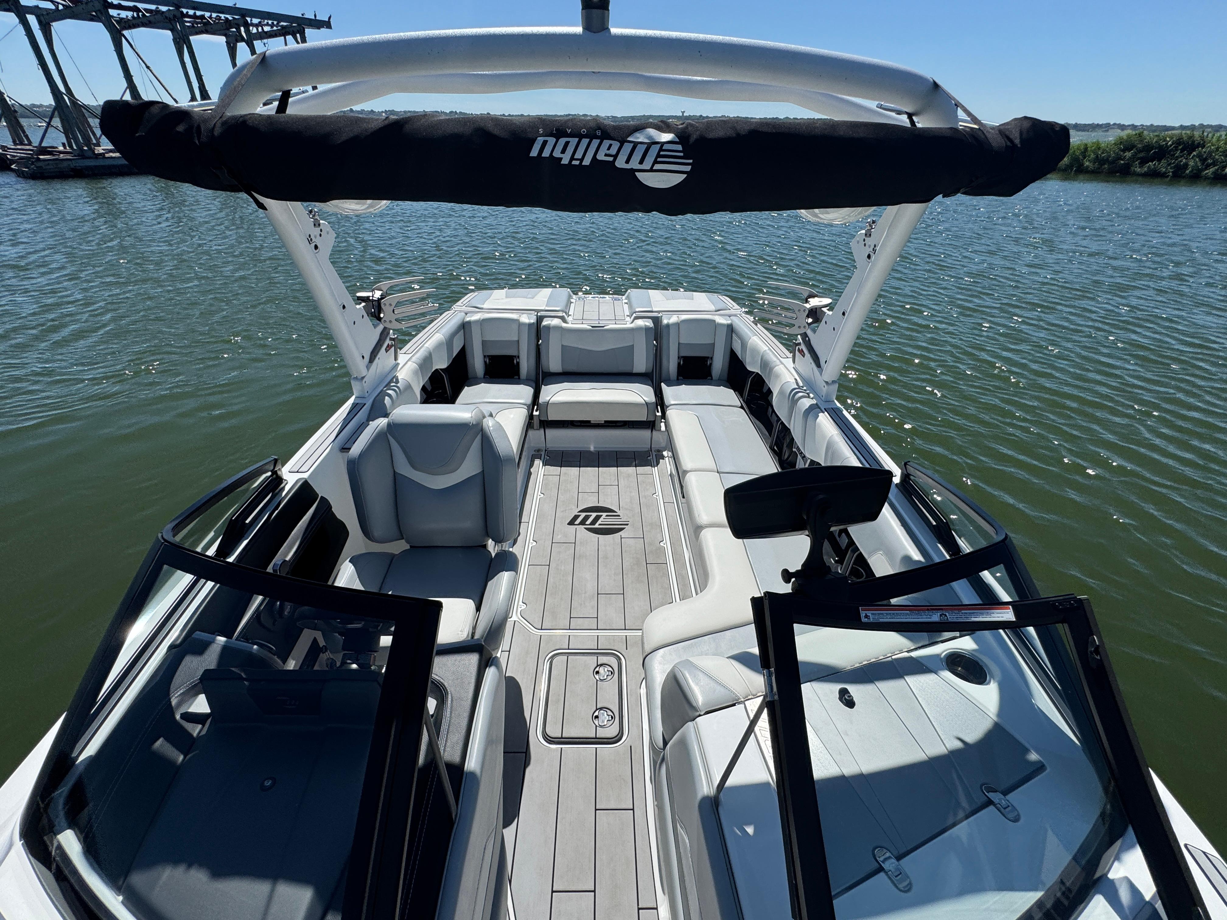 2022 Malibu Wakesetter 24 MXZ boat interior with spacious seating on a sunny day.