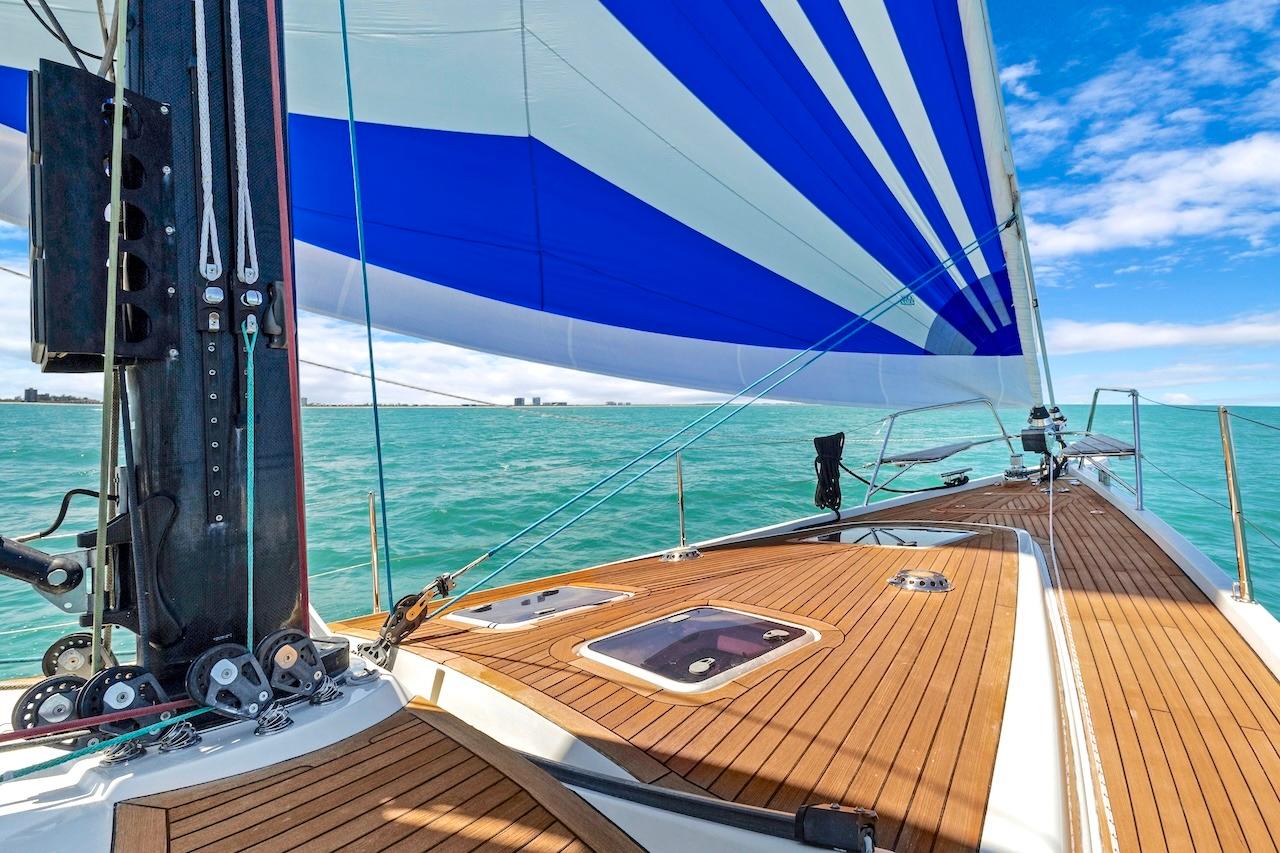 Sailing on a 2011 Southerly 57 RS yacht with blue and white sails over turquoise waters.