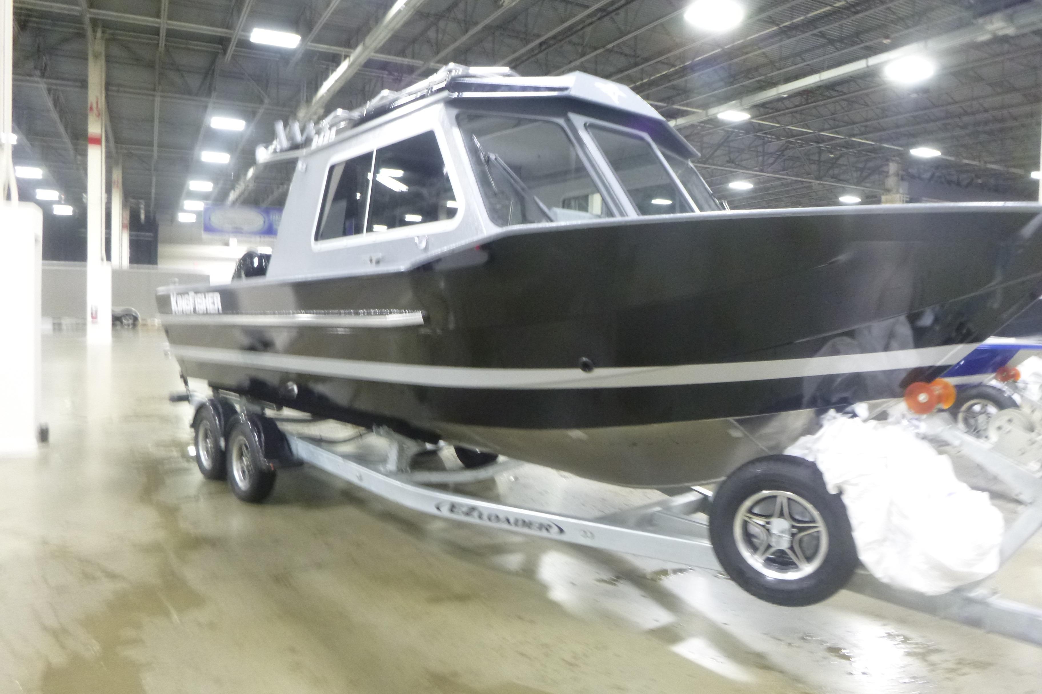 2026 KingFisher 2425 Escape HT boat on trailer in indoor showroom.