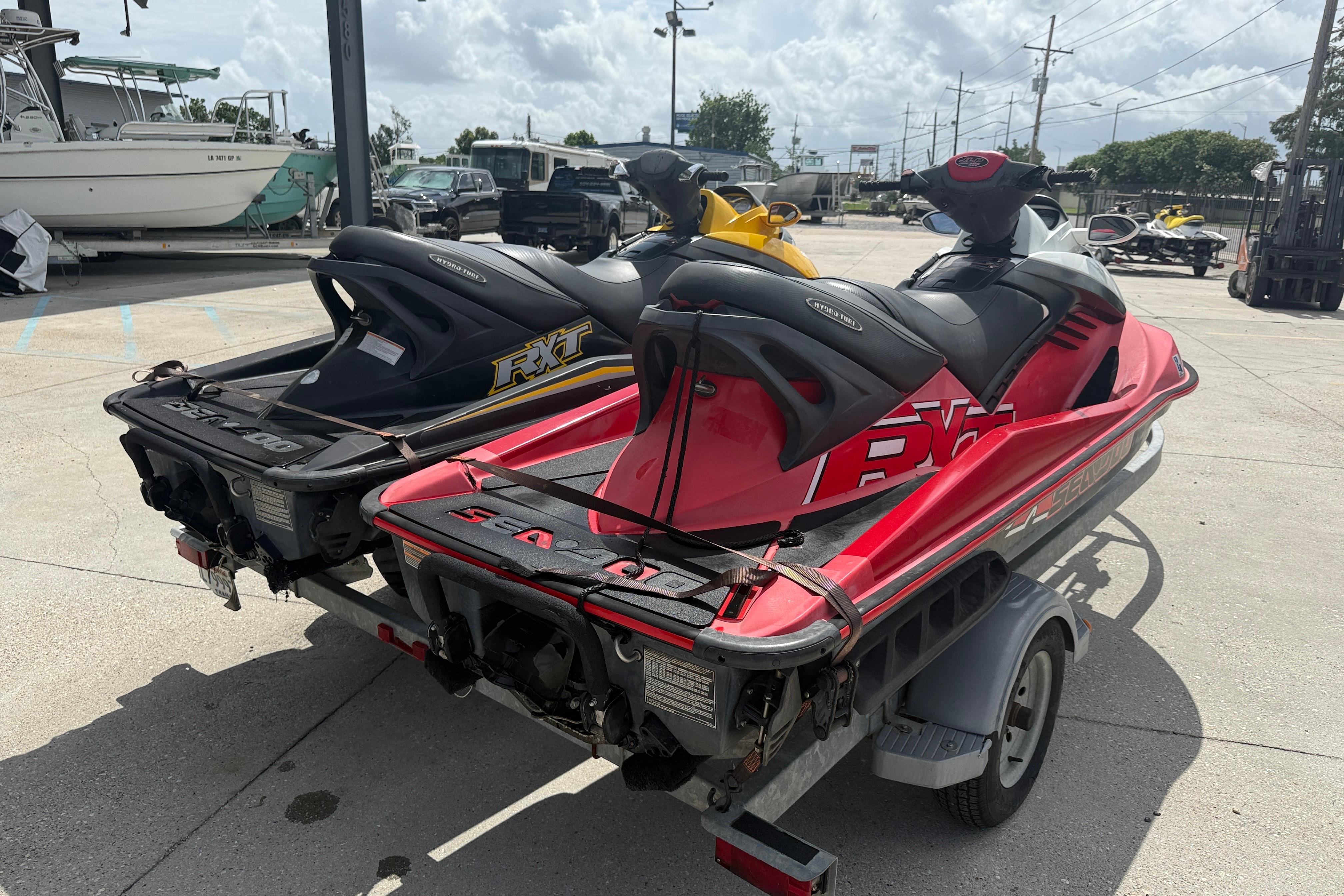 2007 Sea-Doo RXT 215 jet skis on trailer, parked outdoors.