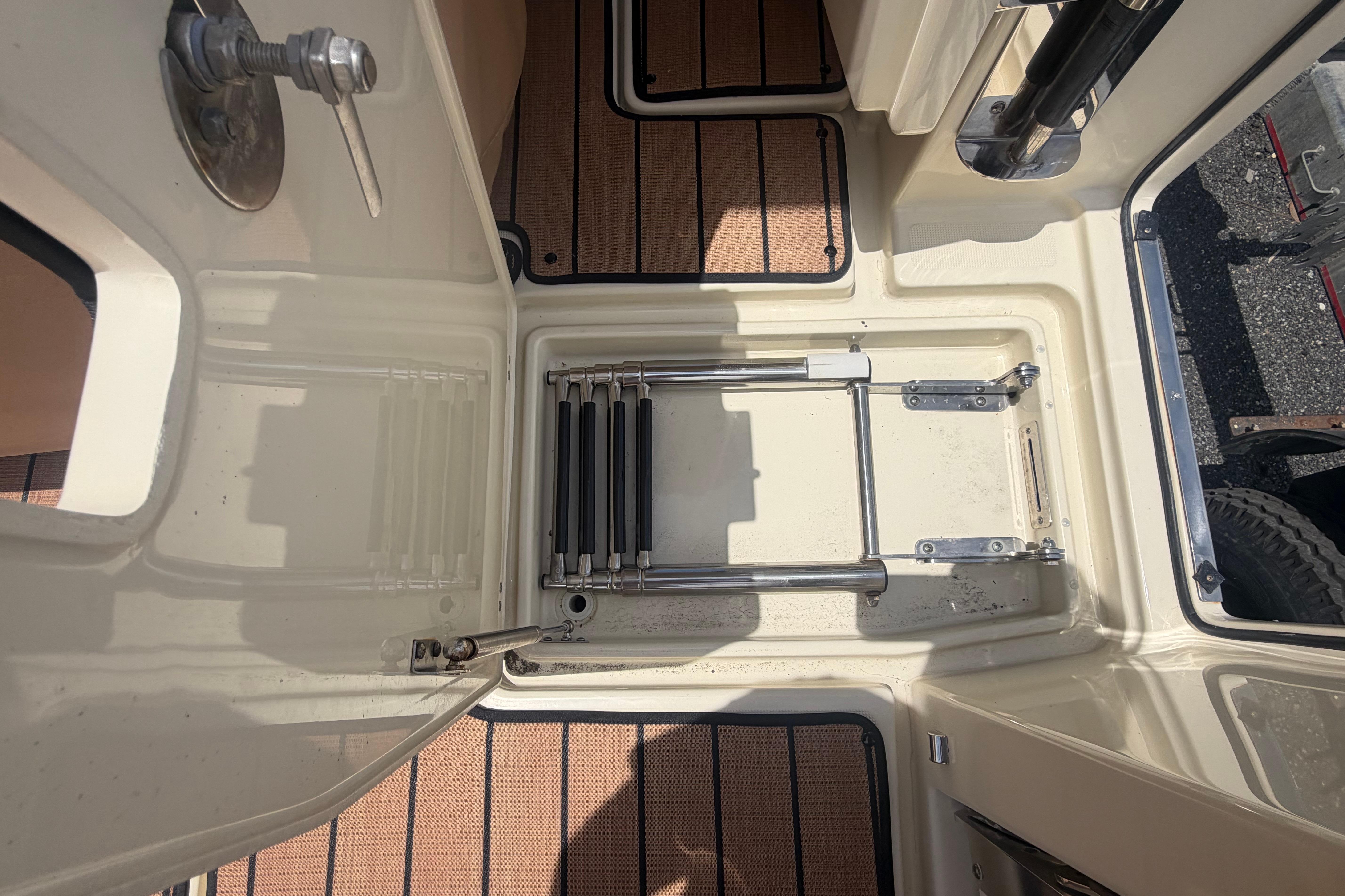 2017 Chris-Craft Catalina 34 boat interior with foldable ladder and teak flooring.