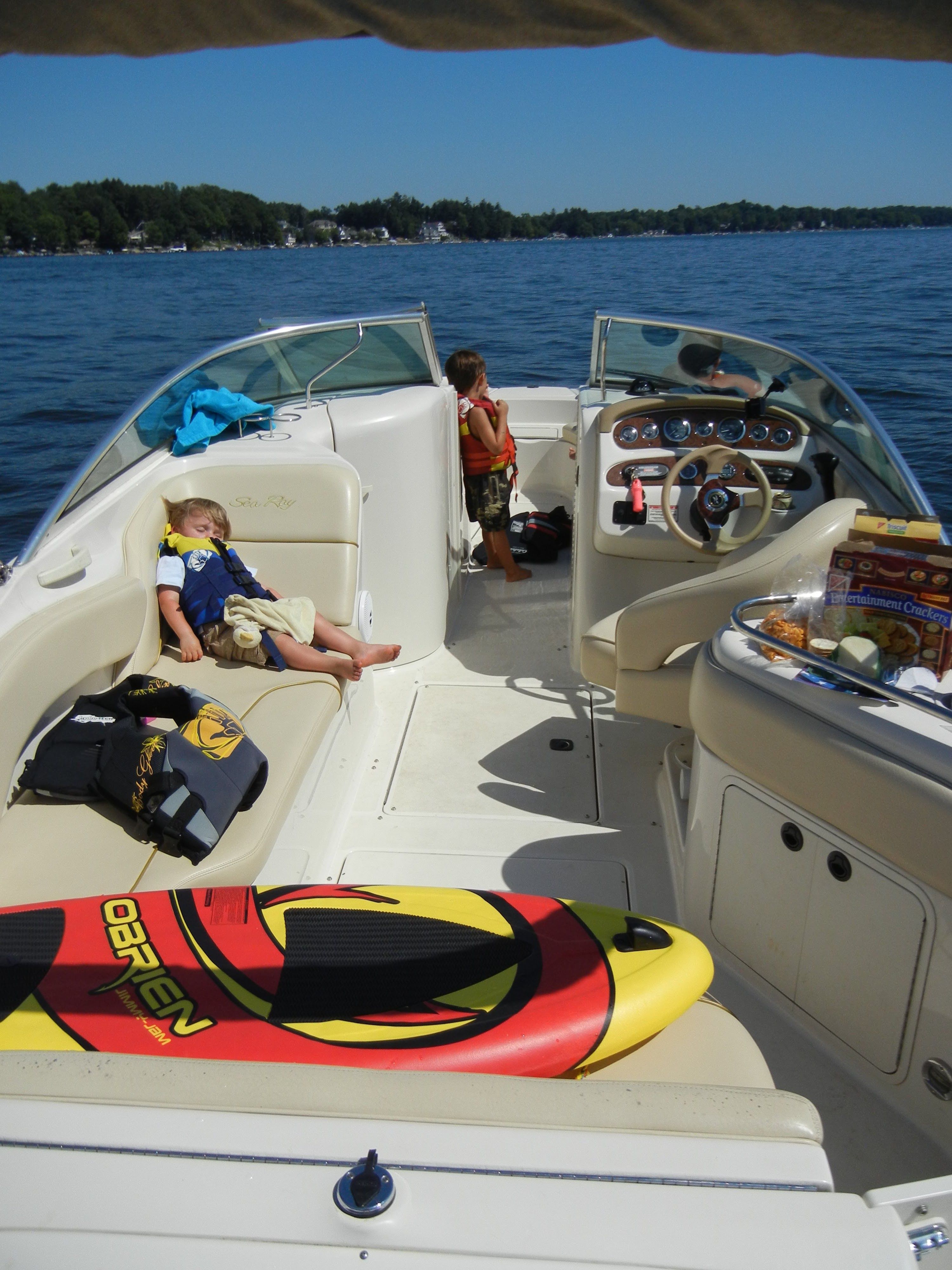 Children relaxing on a 2001 Sea Ray 240 Sundeck boat.