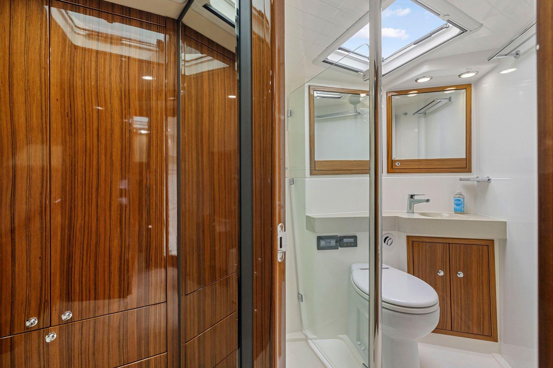 Luxurious bathroom in 2014 Maritimo M50 yacht with wood accents and modern fixtures.