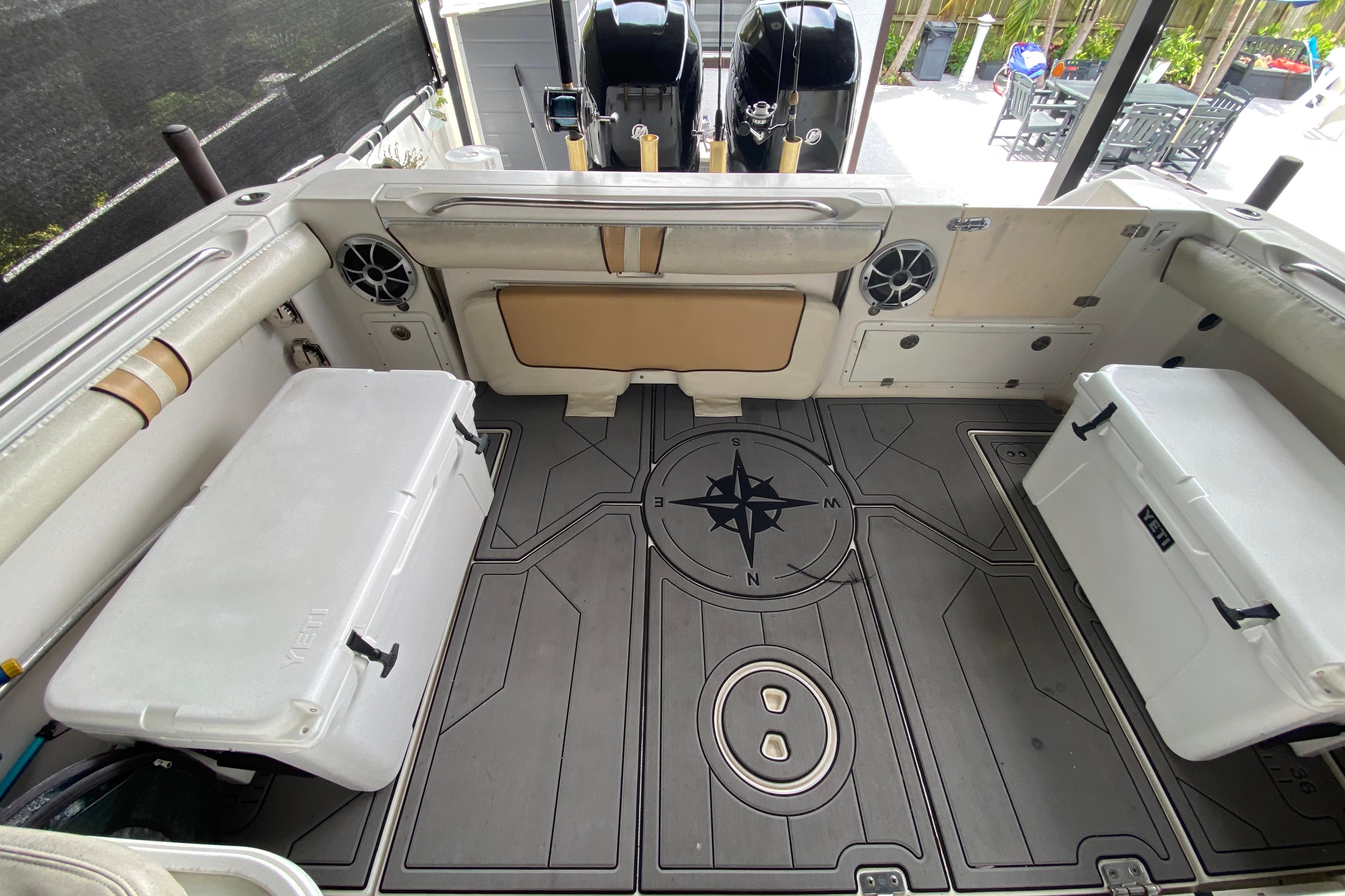 2005 Wellcraft 290 Coastal boat interior with compass design flooring and dual coolers.