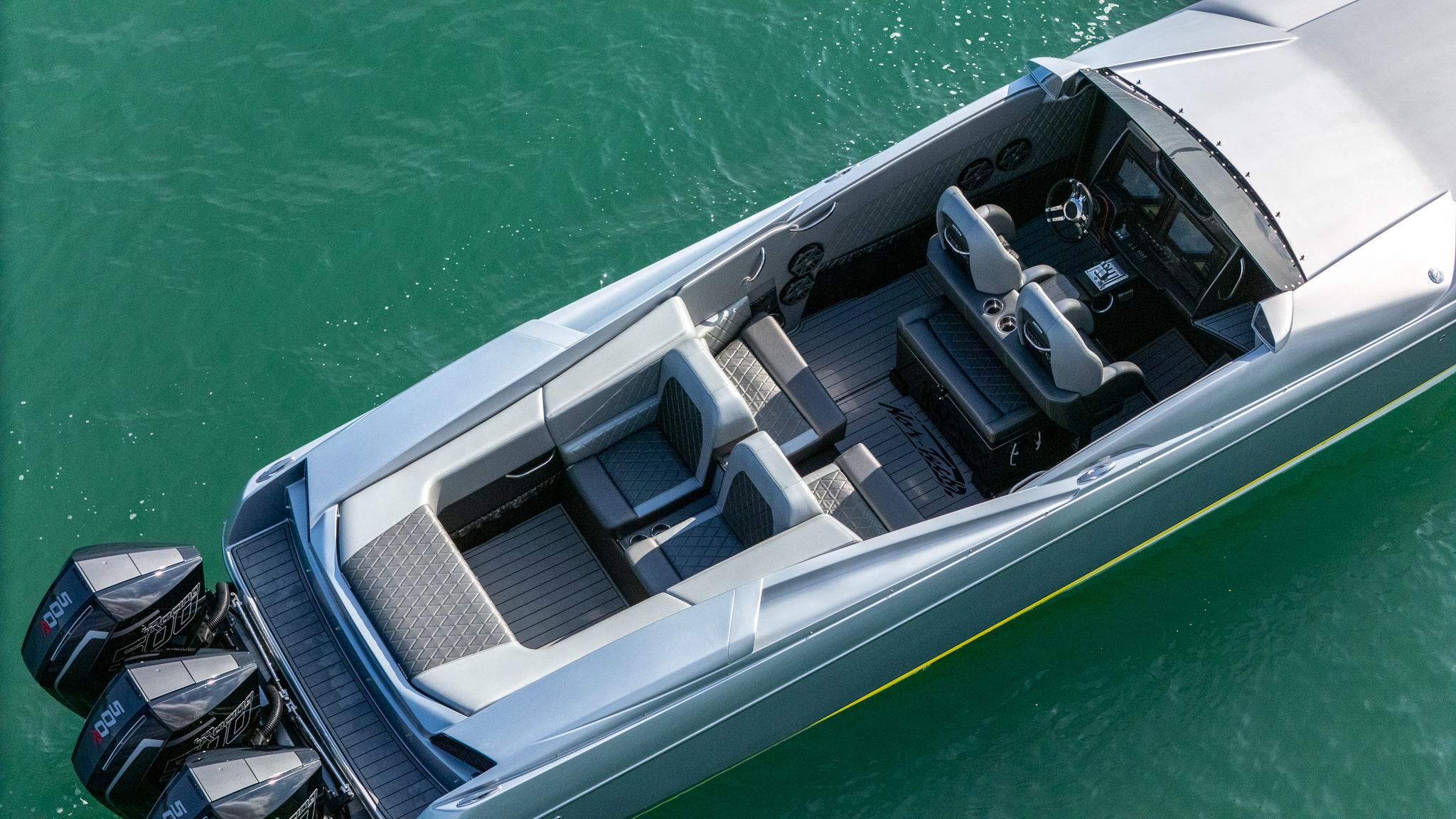 2017 Nor-Tech 3900 Super-VEE boat with triple outboard engines on turquoise water.