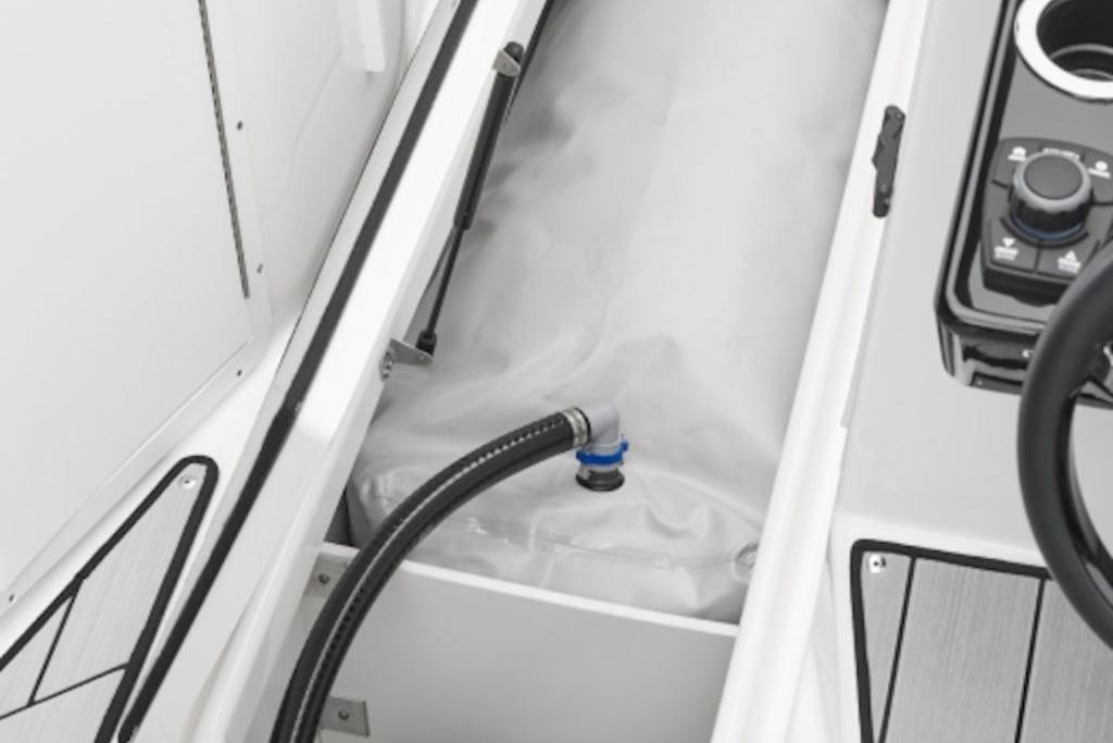 Yamaha Boats 2026 222XE interior detail showing storage compartment and control panel.