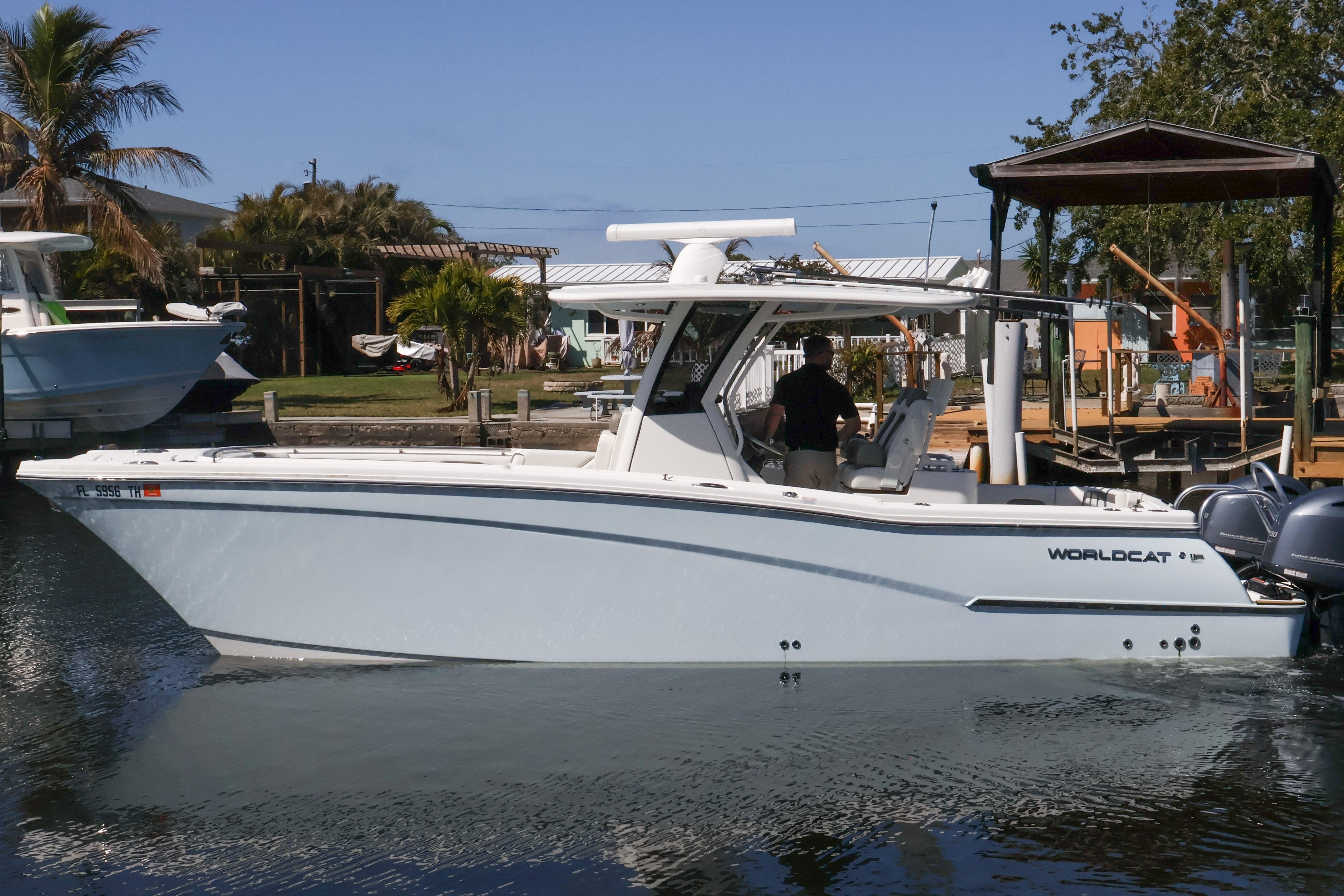 2022 World Cat 280 CC-X boat docked in a sunny marina setting.