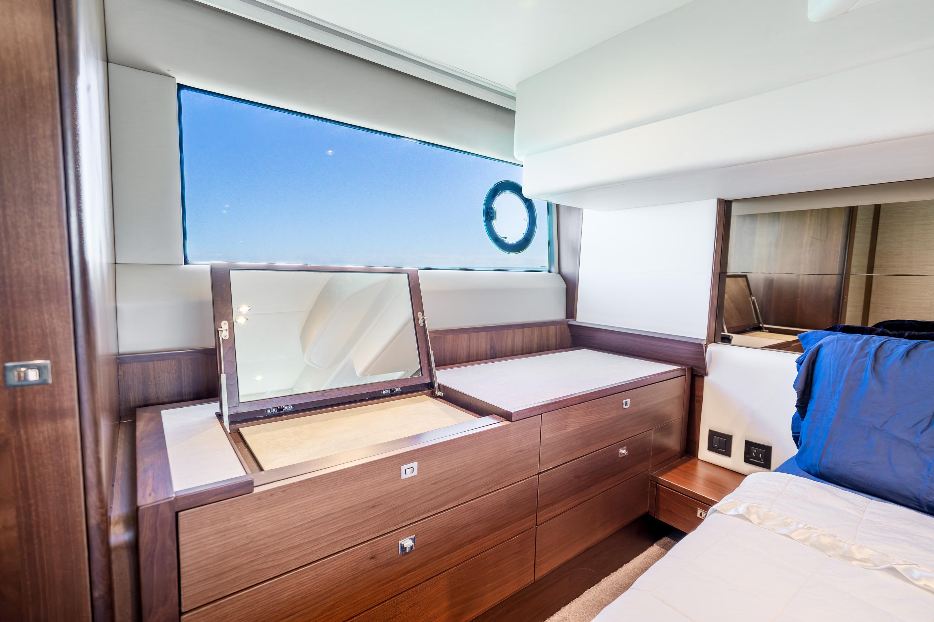Luxurious interior of 2018 Princess F49 yacht with elegant wood finish and vanity mirror.