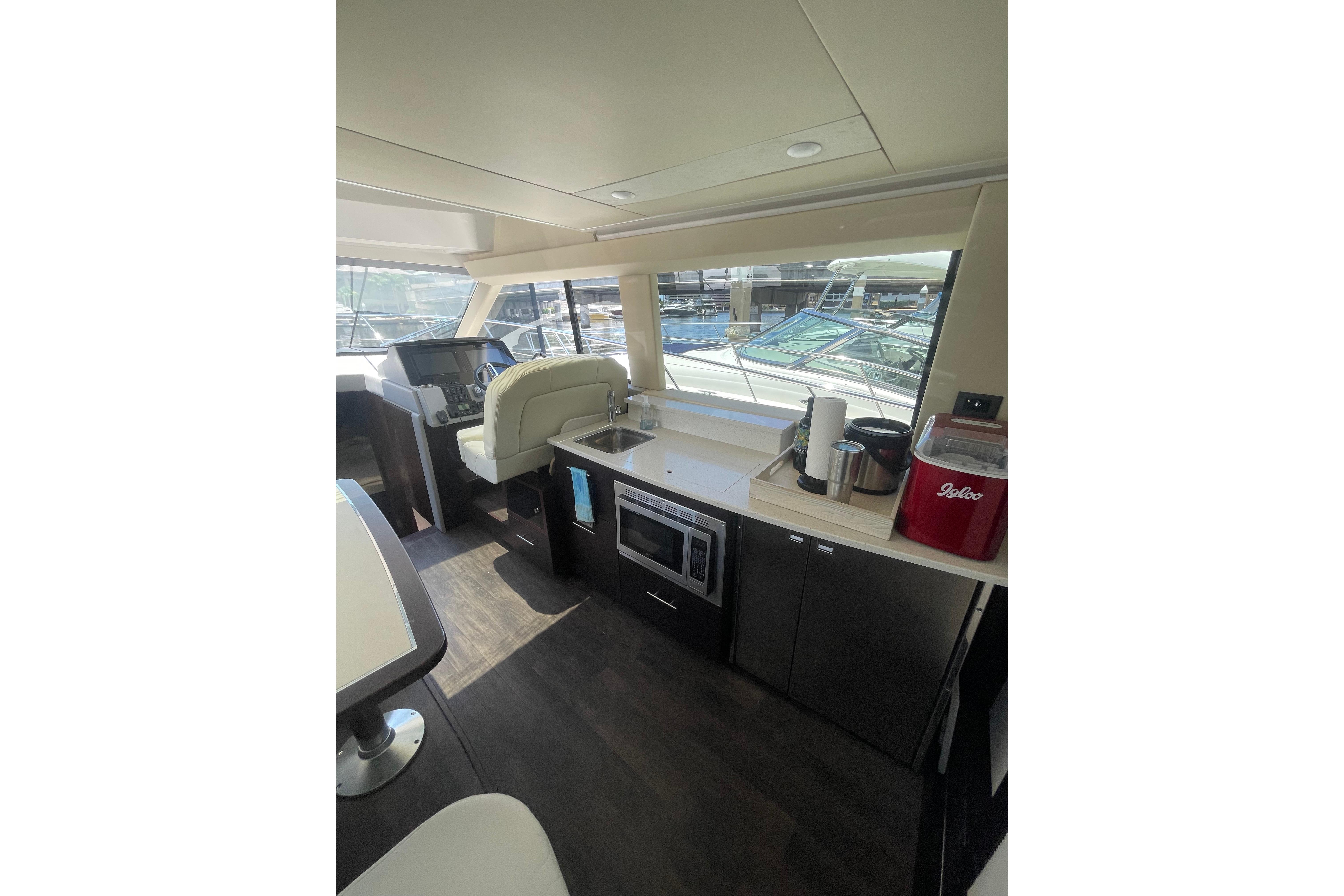 Interior of 2020 Regal 42 Grande Coupe yacht with modern kitchen and helm station.