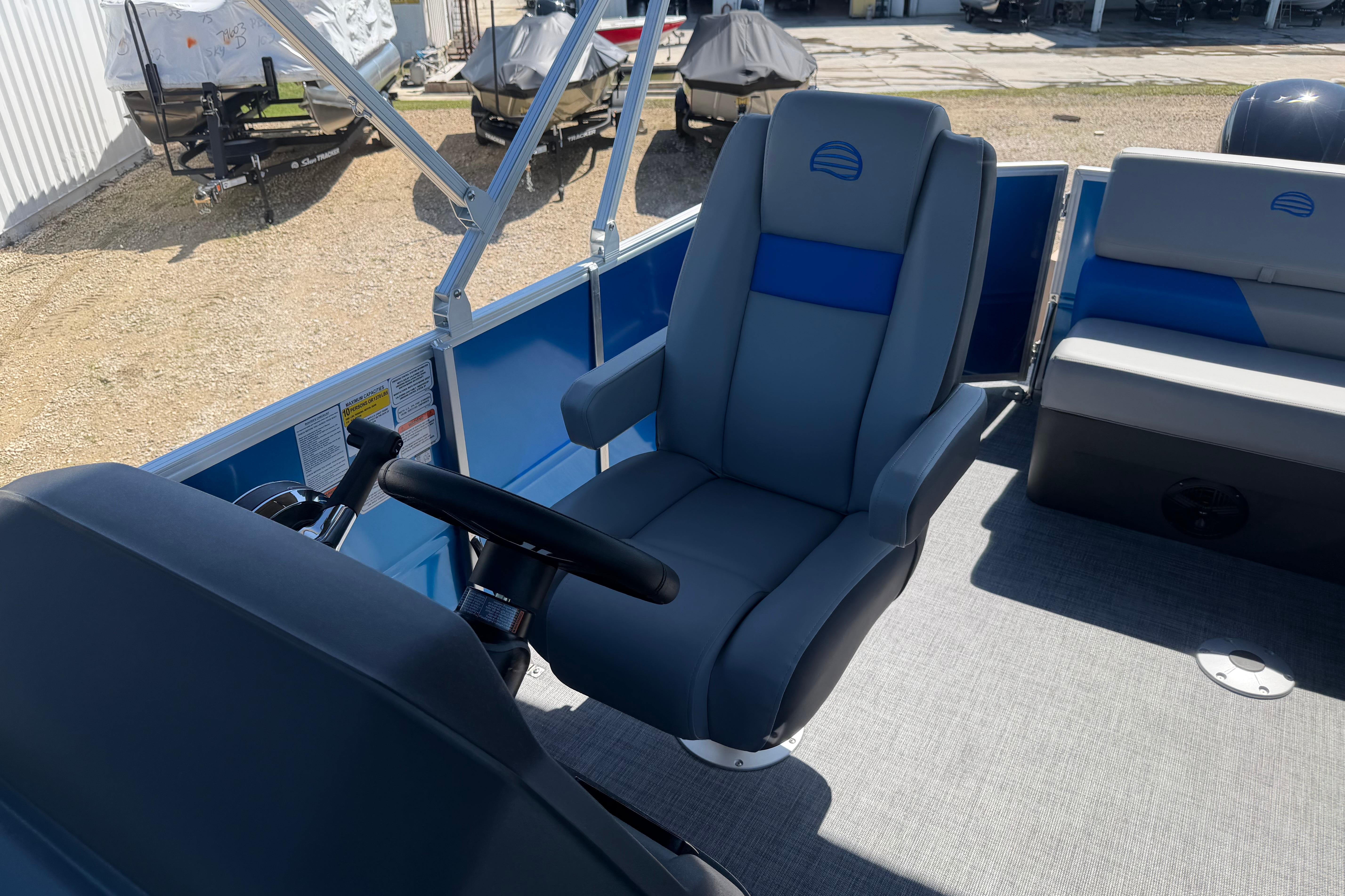 2026 Sun Tracker Party Barge 20 DLX interior with steering wheel and seating.