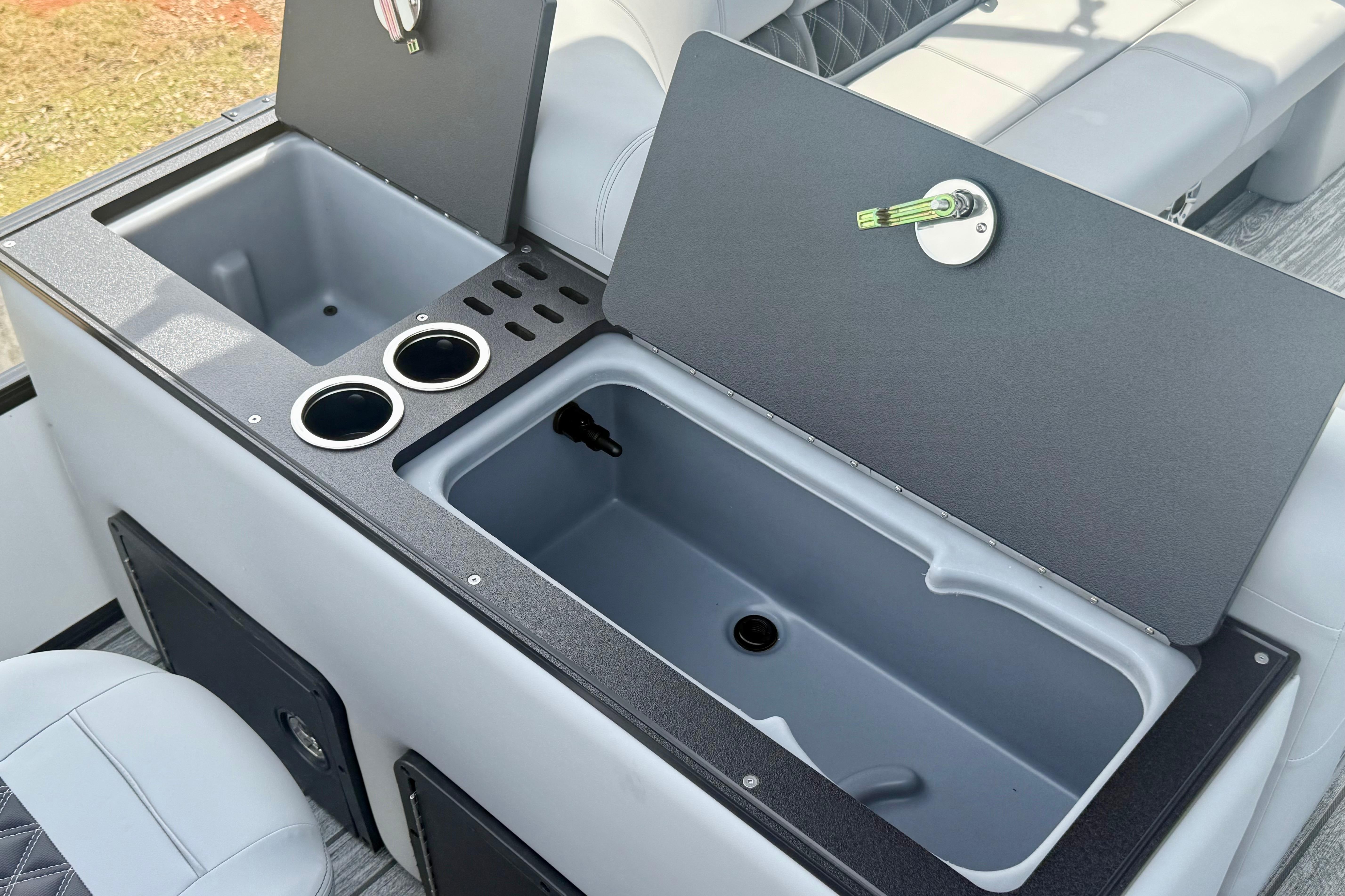 Interior of 2026 Ranger 223FC boat featuring storage compartments and cup holders.