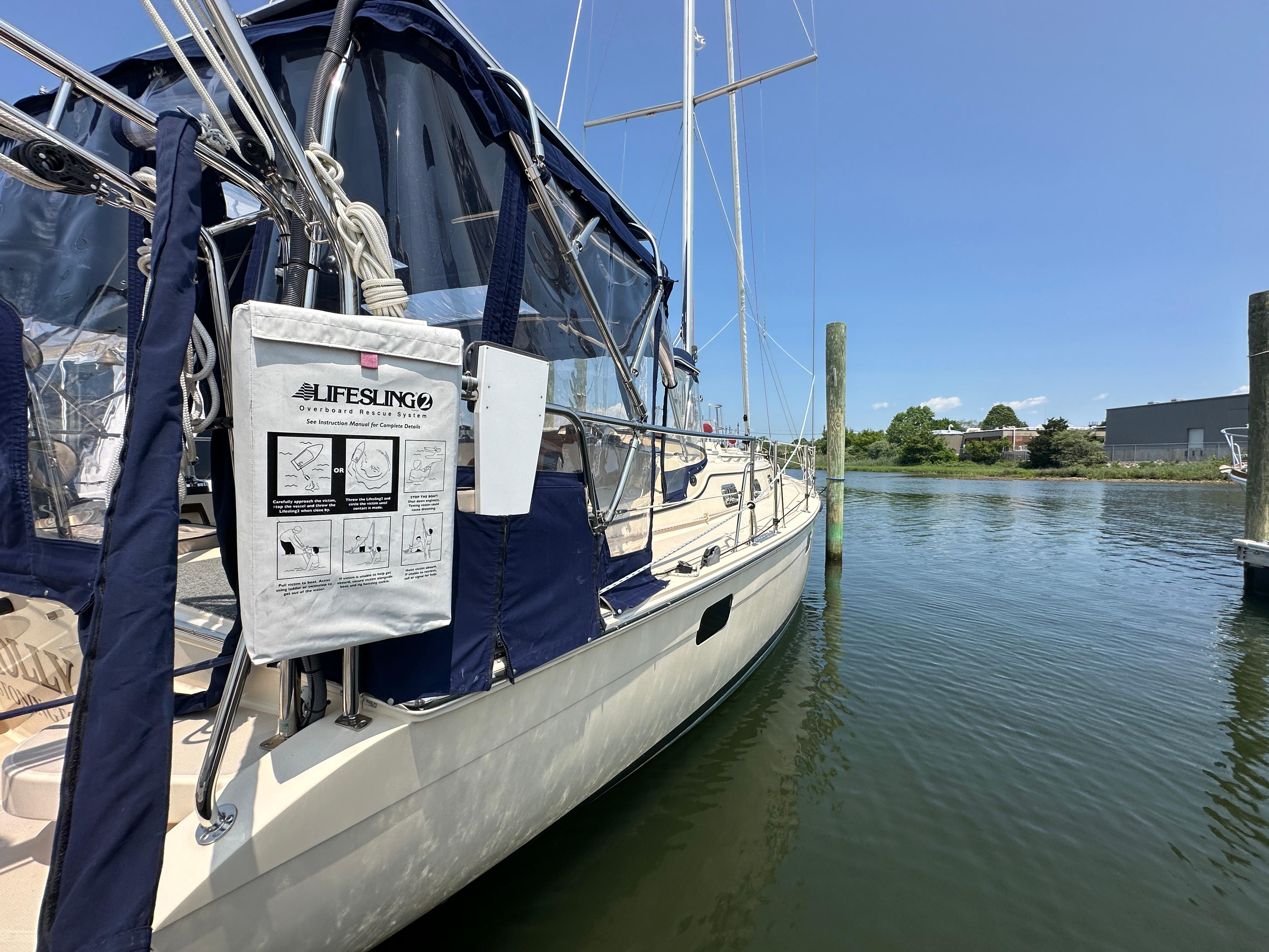 Sailboat Island Packet 439, 2021 model, docked with Lifesling rescue system visible.