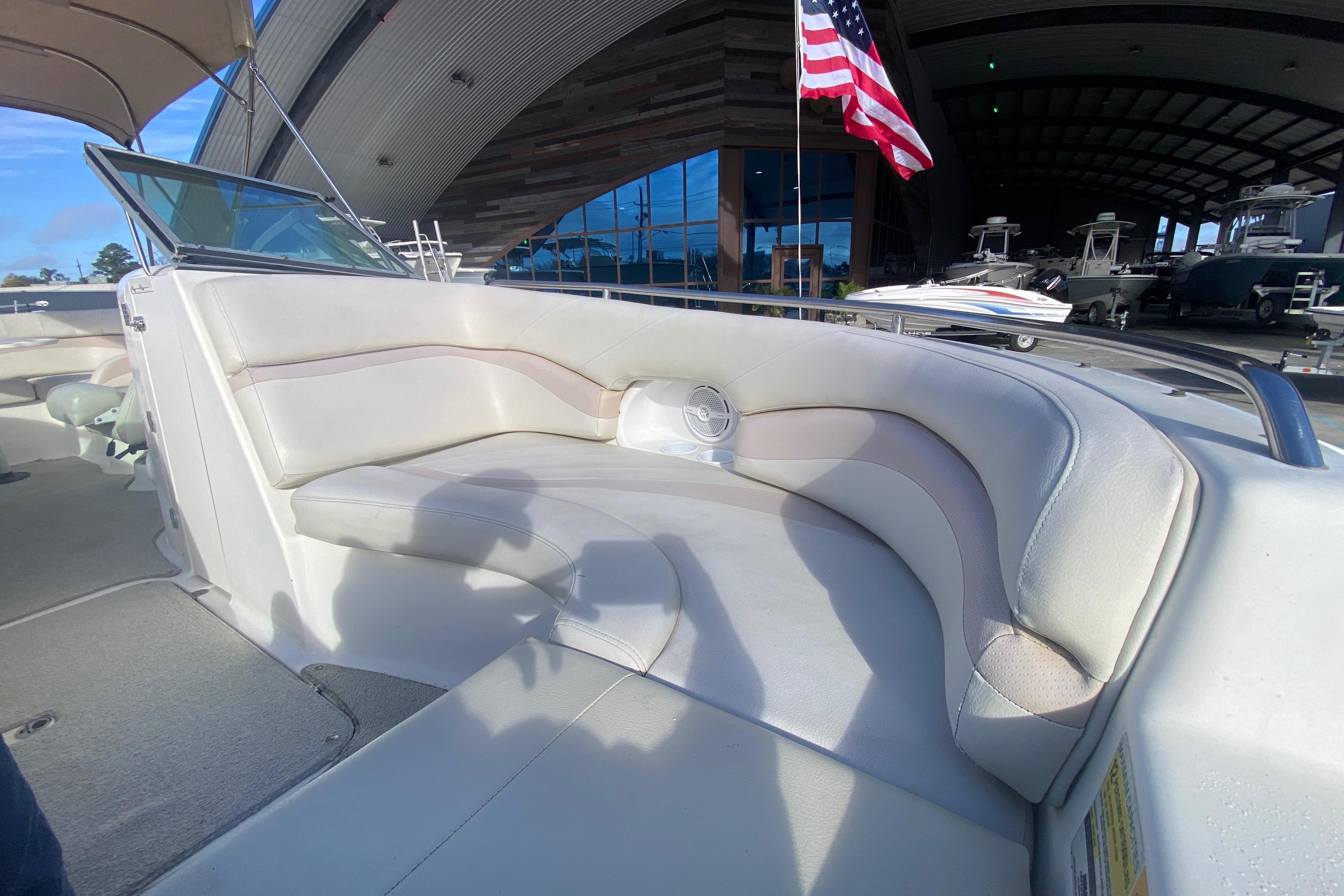 2007 NauticStar 230DC Sport Deck boat interior with cushioned seating and American flag.