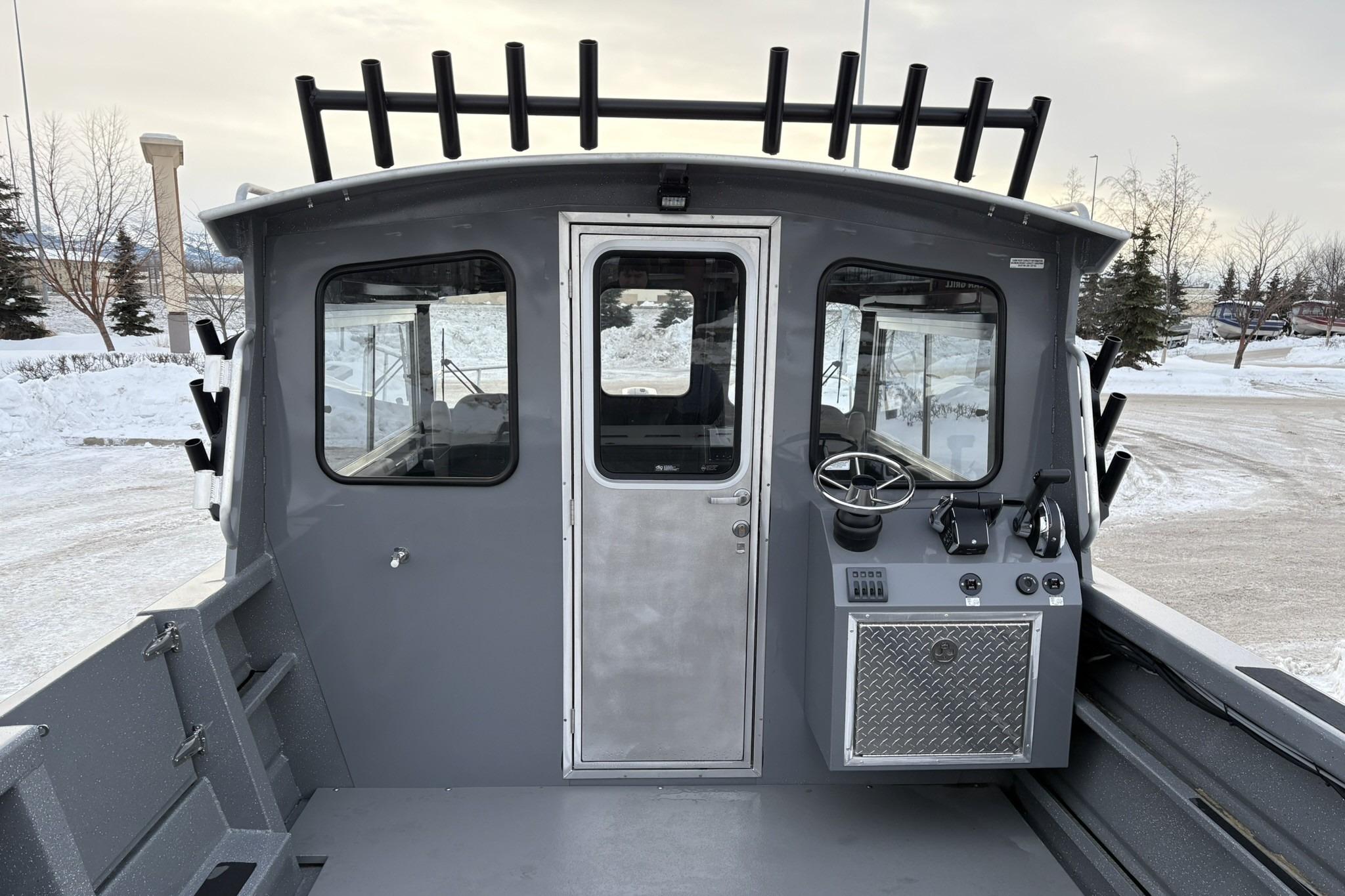 2024 Spartan 26 Maximus Pro XL boat, gray exterior, snowy background, docked.