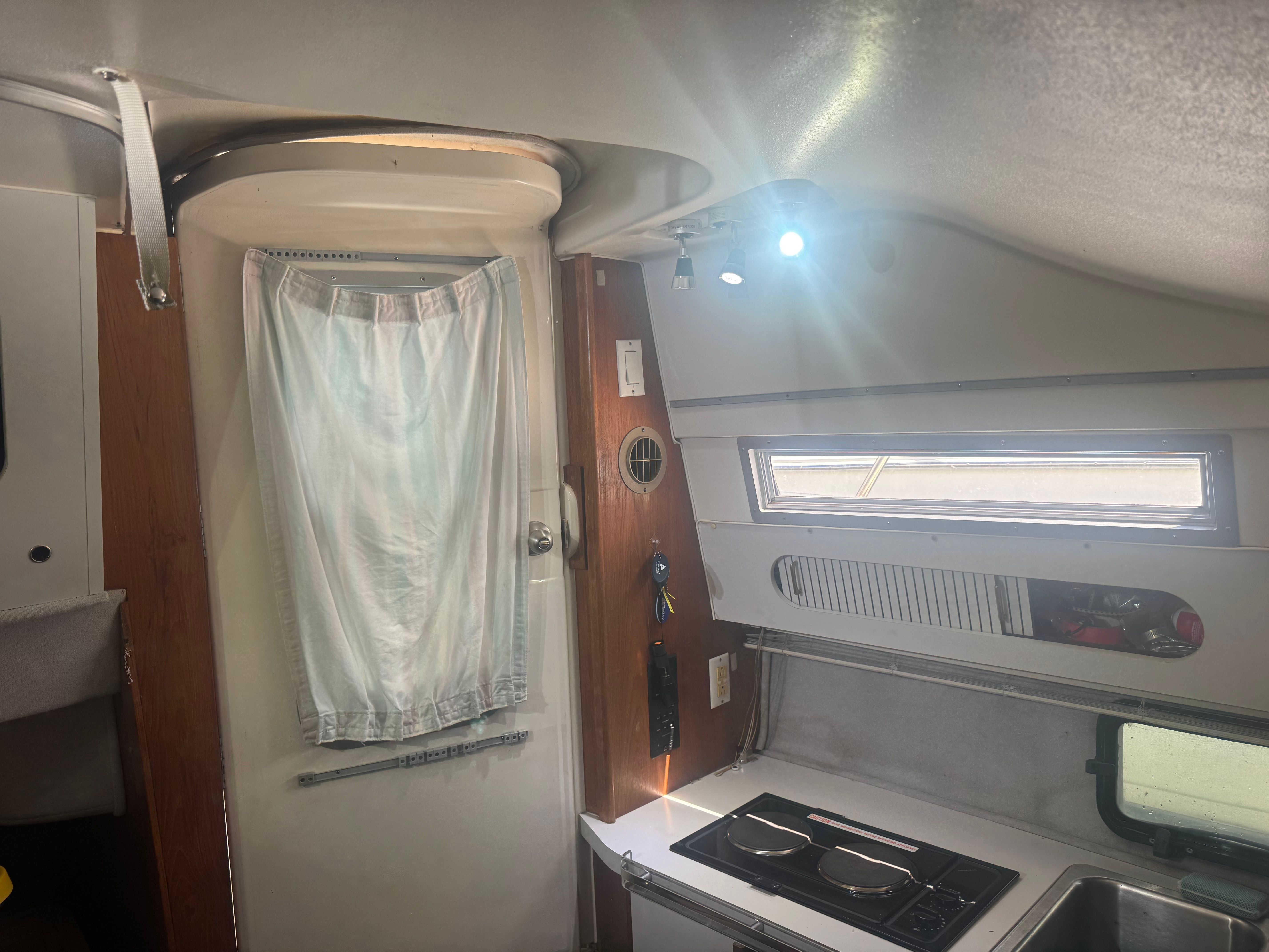Interior of a 1992 Cruisers Yachts Esprit 3370 with stove and window.