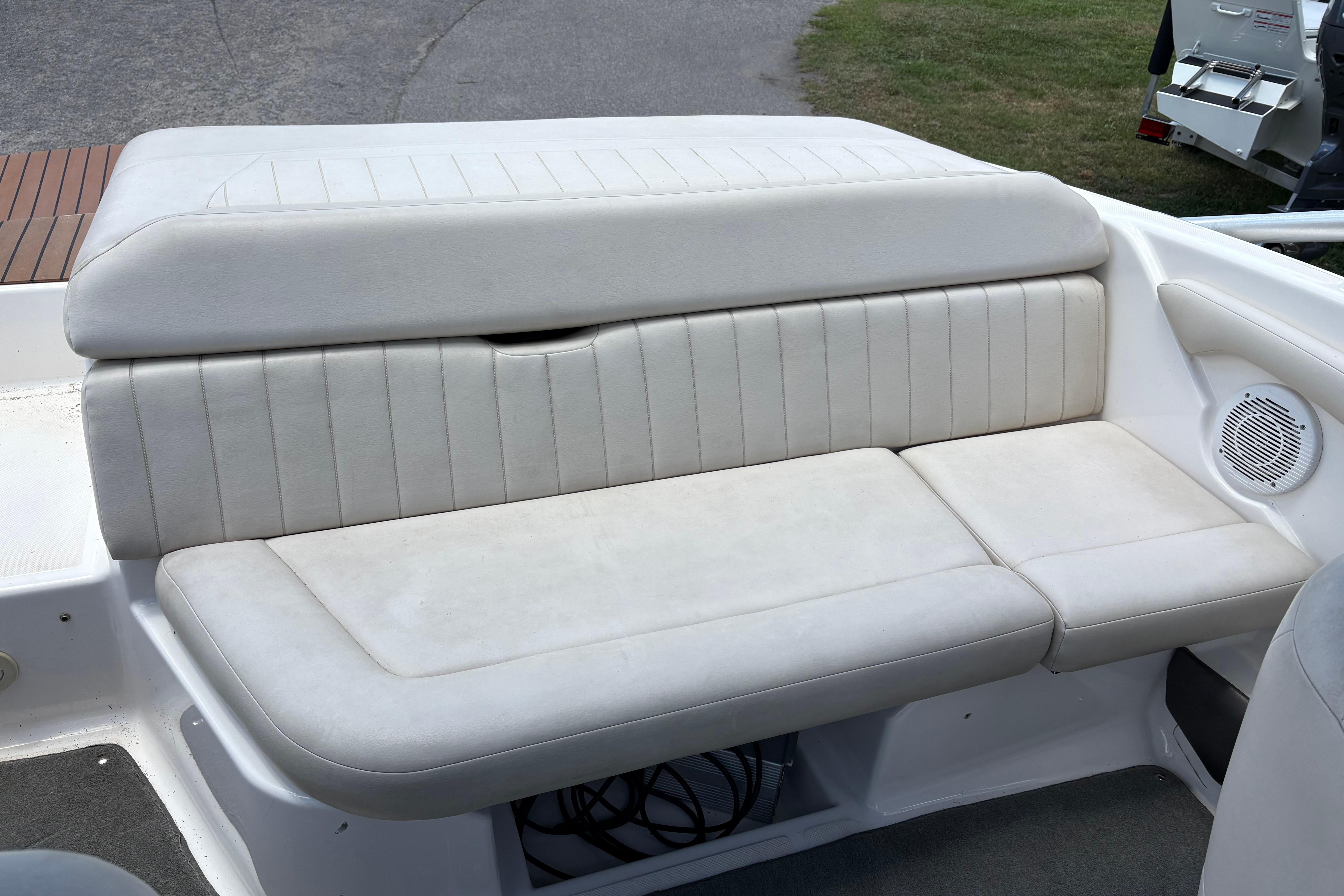 2008 Regal 1900 Bowrider boat interior with white cushioned seating and speaker.
