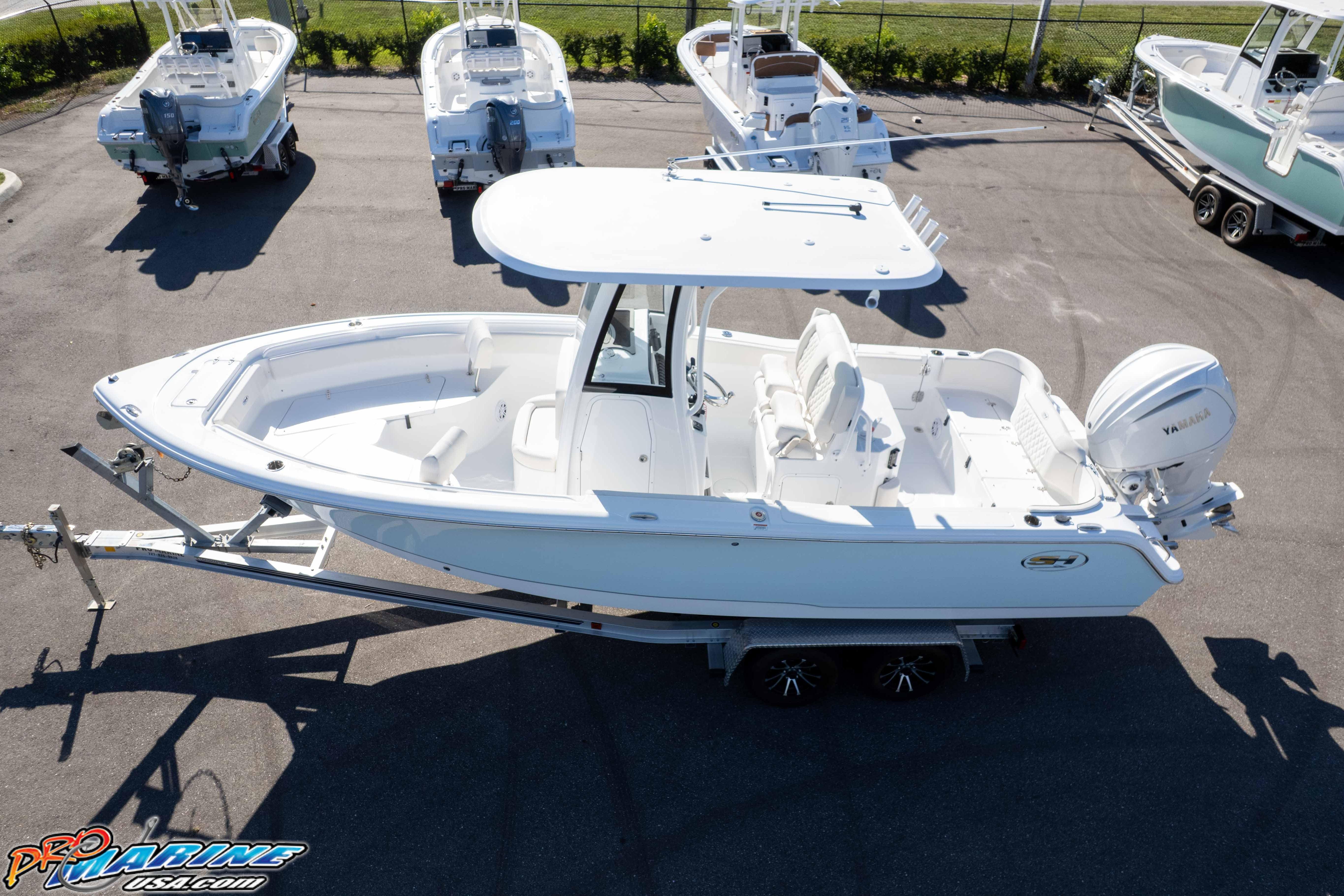2025 Sea Hunt Ultra 245 SE boat on trailer, aerial view, in a parking lot.