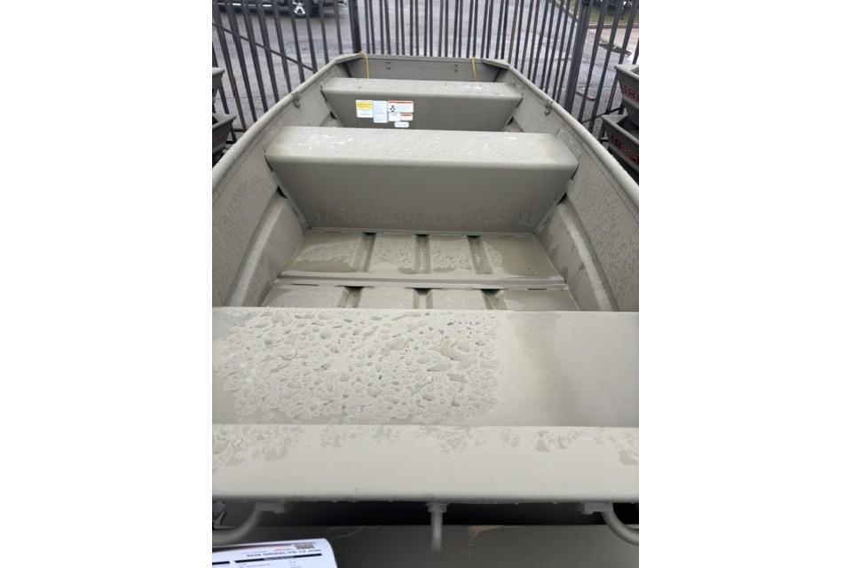 2026 Tracker Grizzly 12 Jon boat interior with wet surfaces and metal benches.