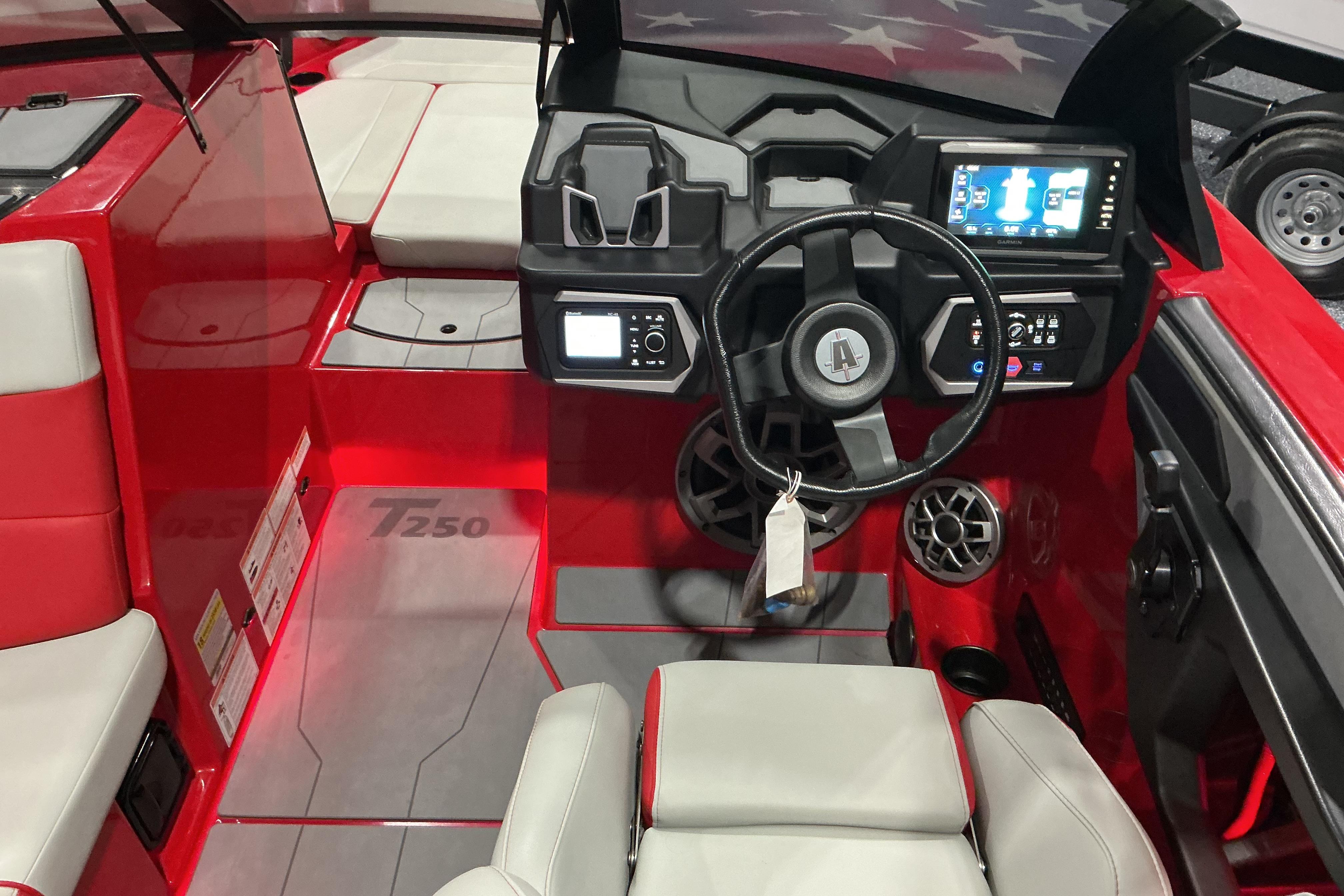 2022 Axis T250 boat interior with red and gray seating, modern dashboard, and steering wheel.