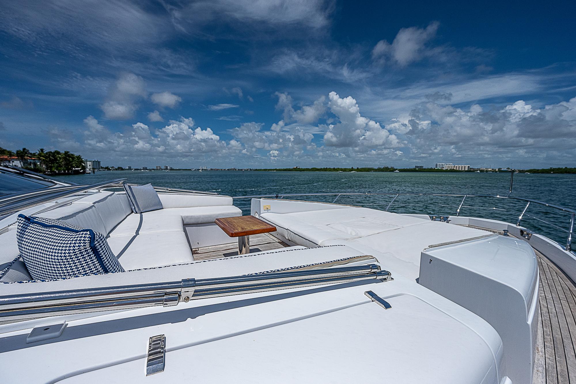 Luxurious 2011 Azimut 82 yacht deck with ocean view and plush seating.