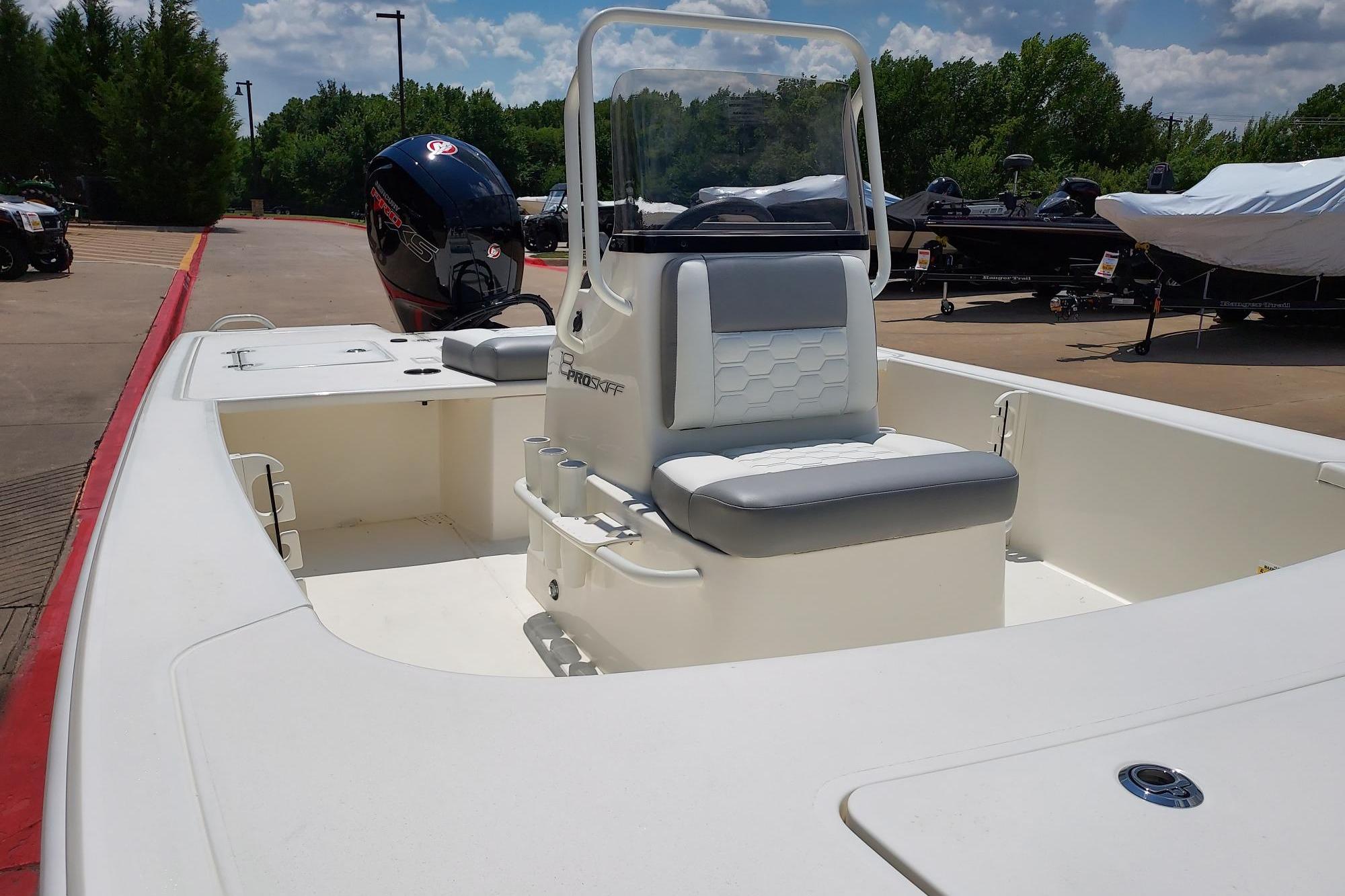 2026 Mako Pro Skiff 18 boat with center console and outboard motor in a marina setting.