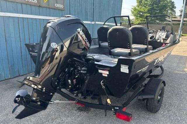 2026 Tracker Pro Guide V-16 WT boat with Mercury engine, parked outdoors.