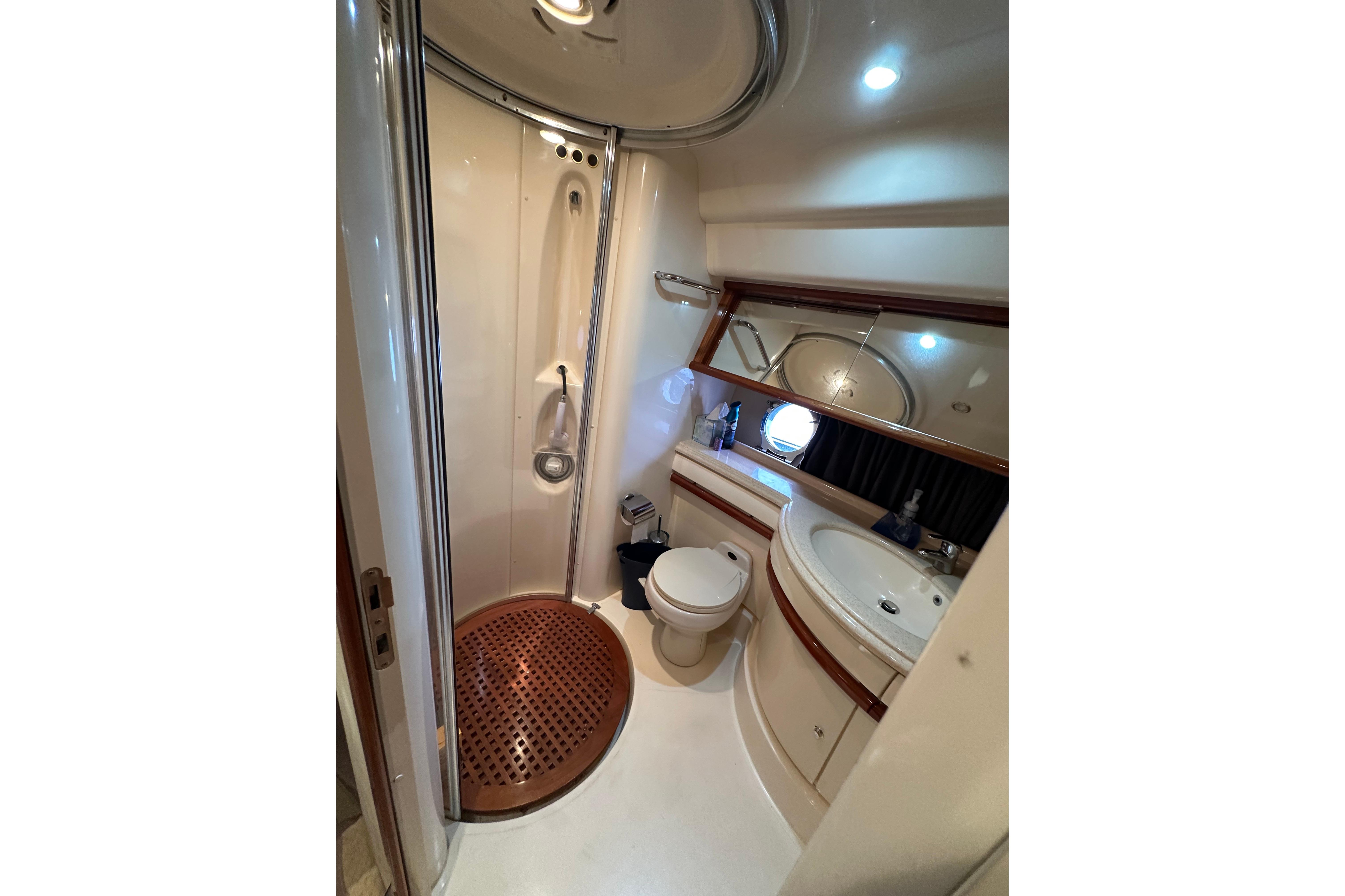 Luxurious 2004 Azimut 55E yacht bathroom with shower, sink, and toilet.