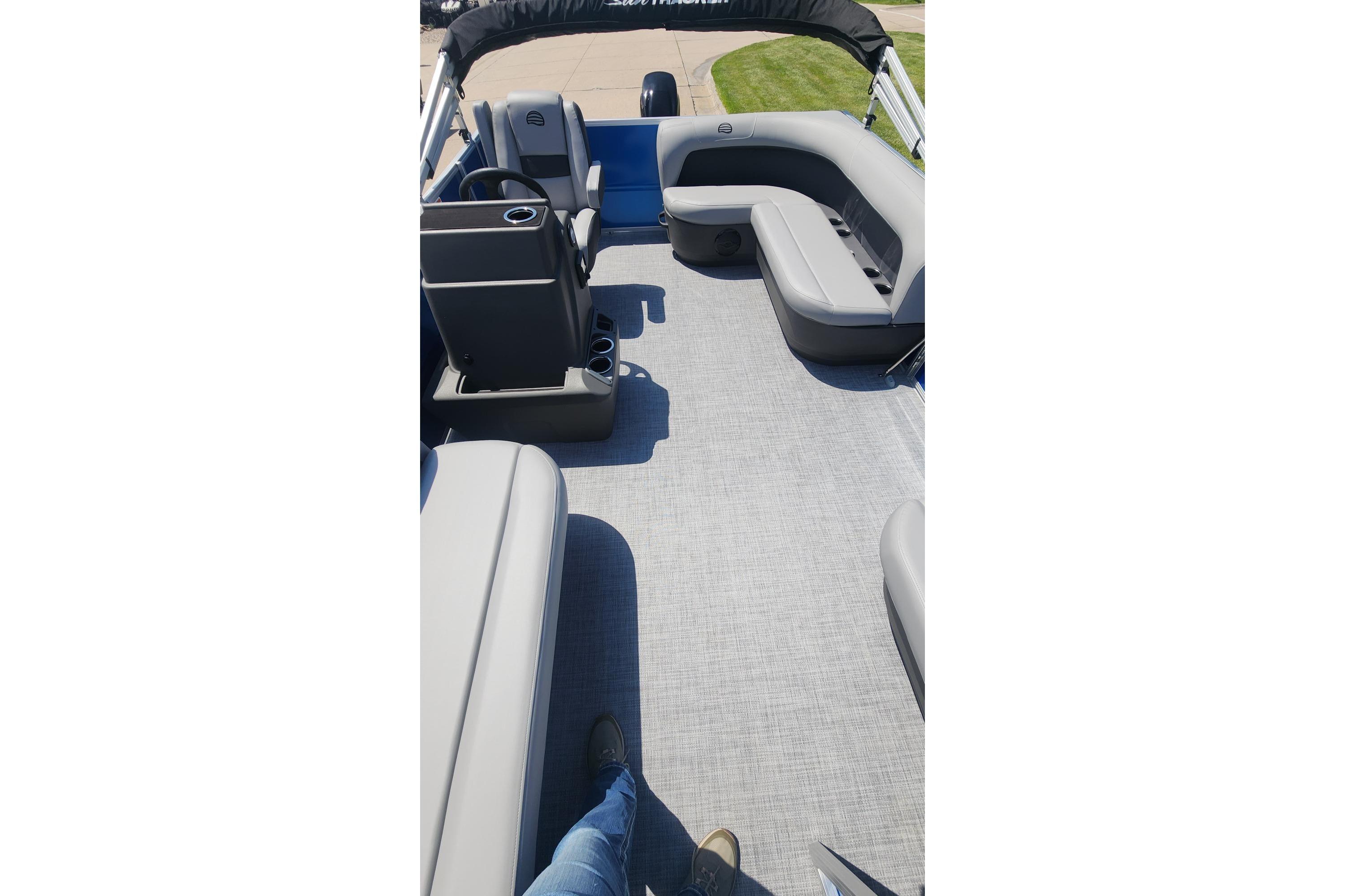2026 Sun Tracker Party Barge 16 DLX interior with gray seating and spacious layout.