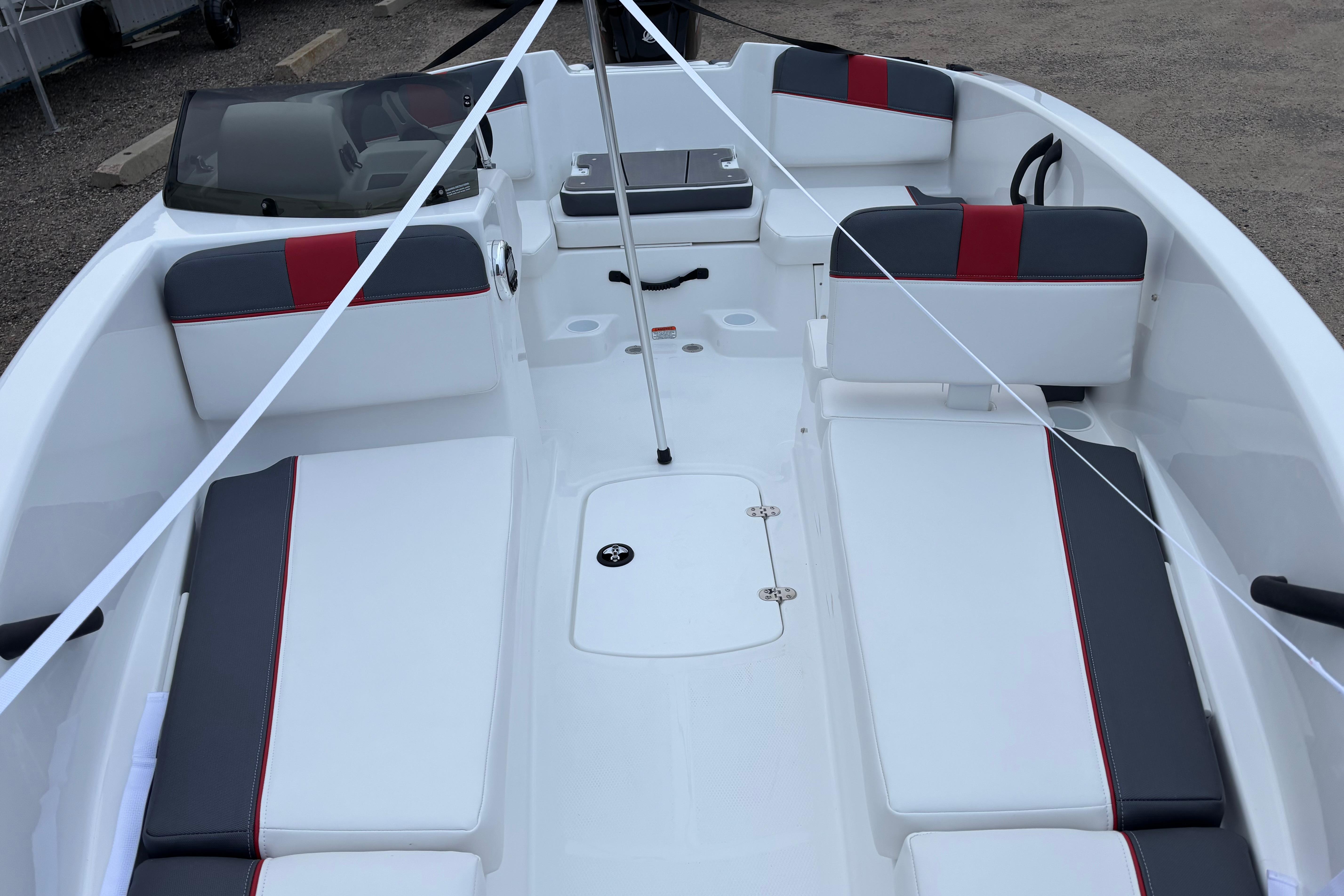 2026 Tahoe T16 boat interior with white and gray seating, red accents, and sleek design.