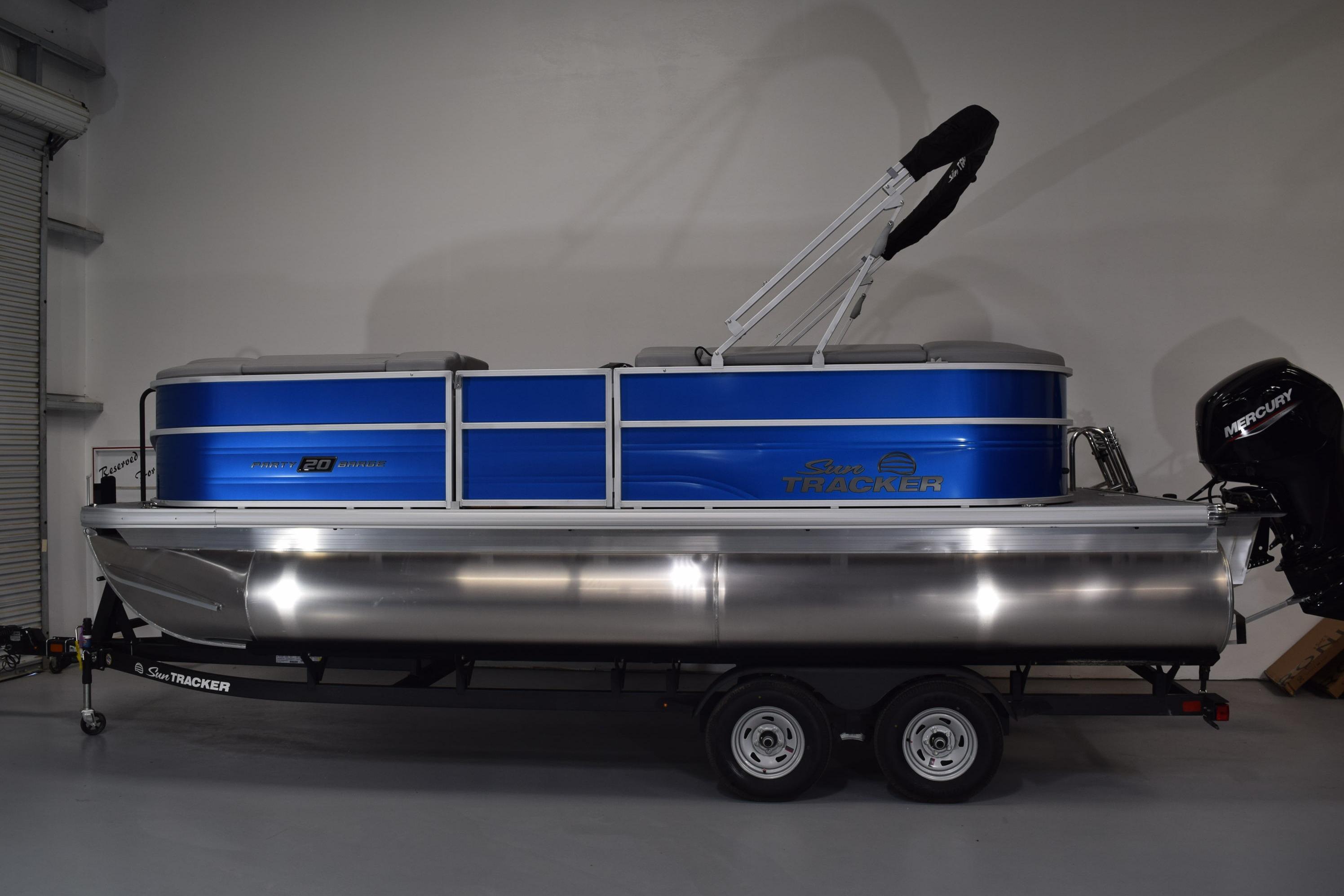 2026 Sun Tracker Party Barge 20 DLX pontoon boat in a showroom setting.