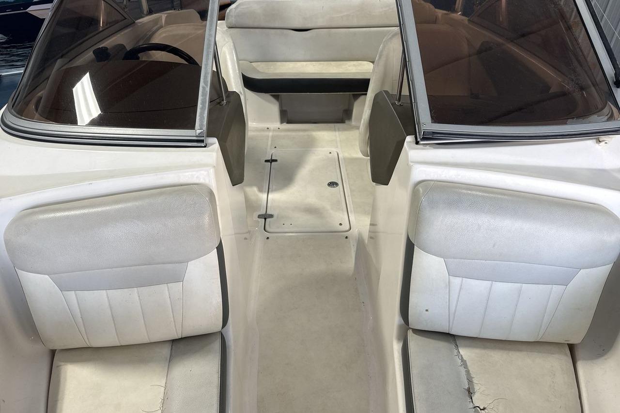 Interior view of a 2012 Regal 1900 Bowrider boat with white seating.
