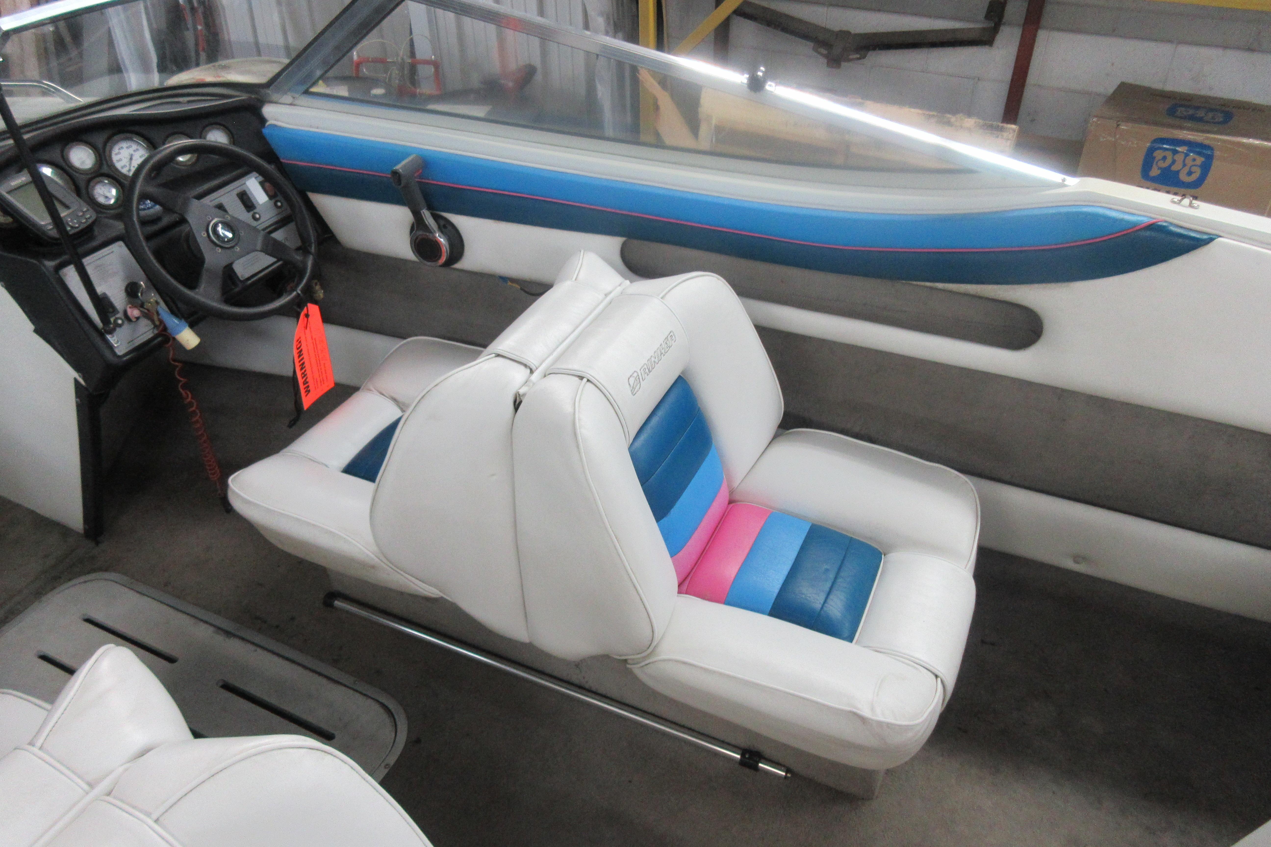 Interior of a 1993 Rinker 186 Captiva Bowrider with white and blue seating.