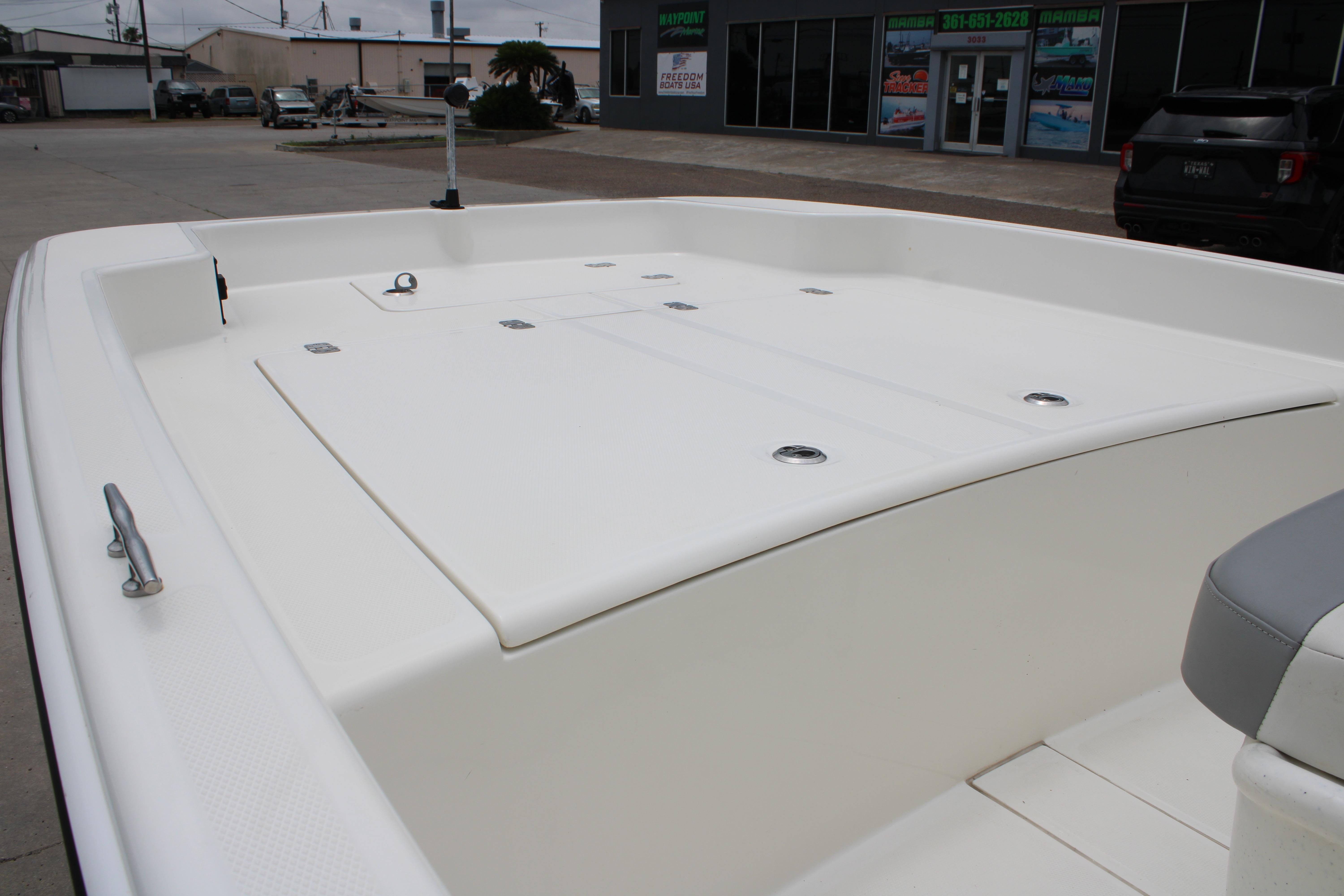 2021 Mako Pro Skiff 17 CC boat deck, spacious and clean, in a dealership lot.