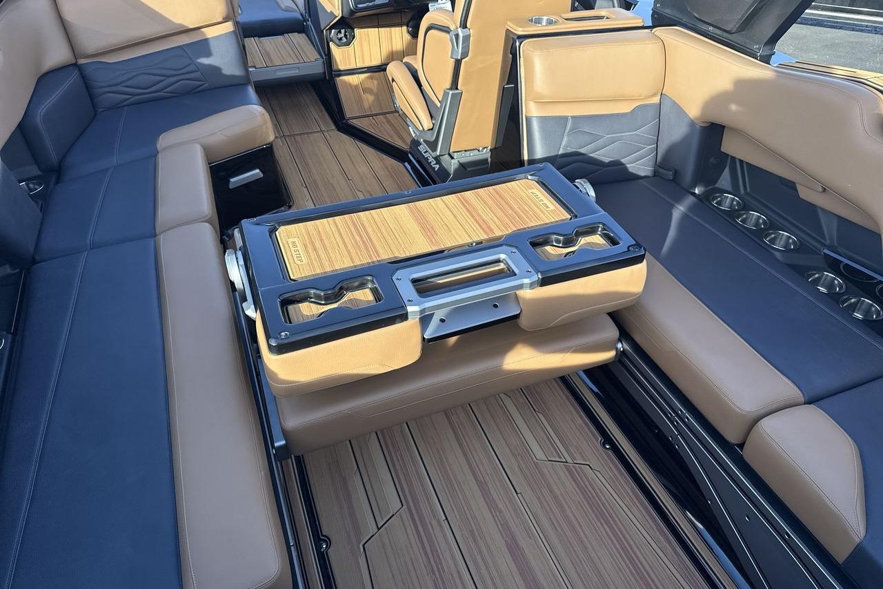 Luxurious interior of 2026 Supra SE 550 boat with premium seating and wood accents.
