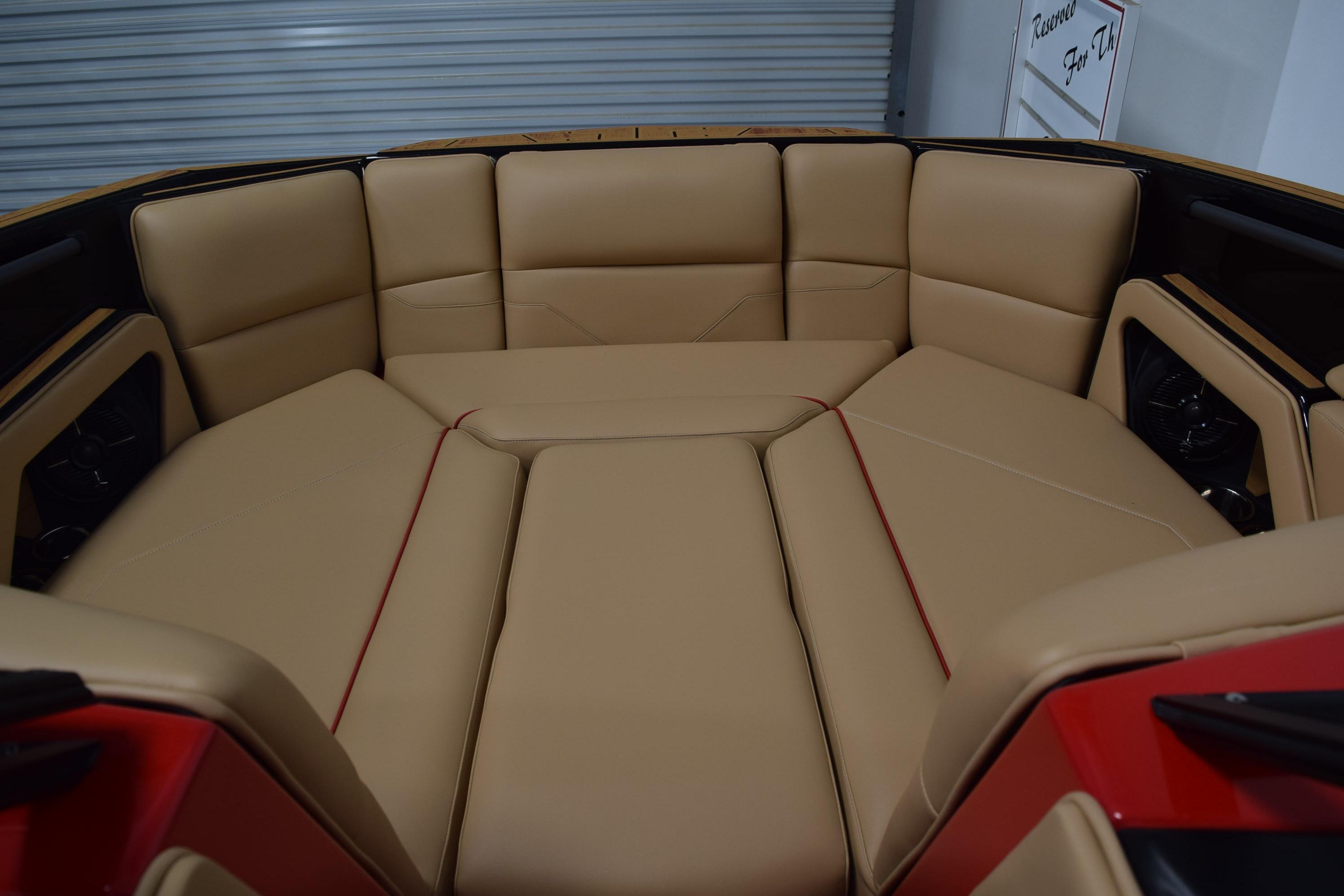 2026 Moomba Max boat interior with tan leather seating and red accents.