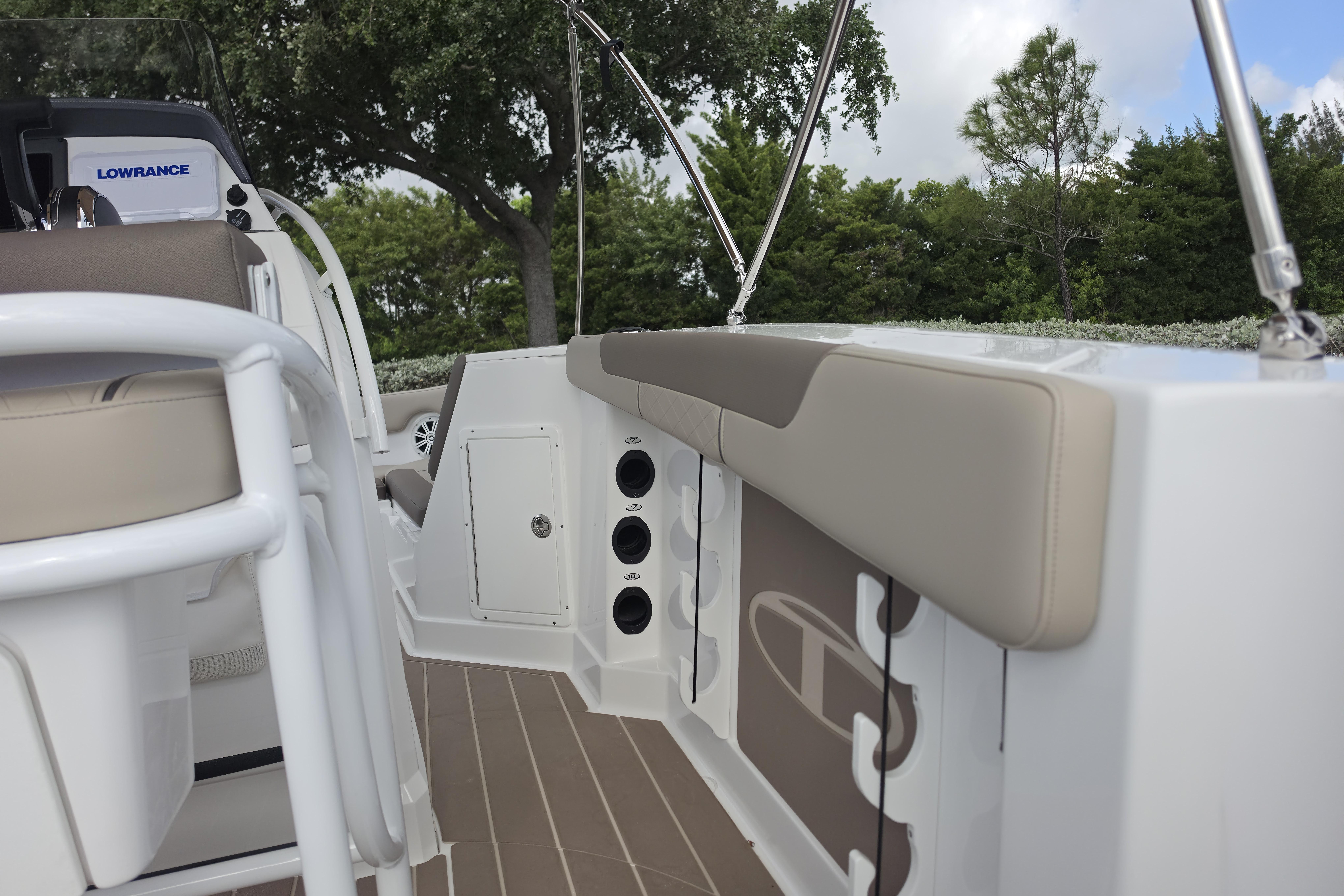 2026 Tahoe 2150 CC boat interior with beige seating and rod holders, featuring Lowrance equipment.