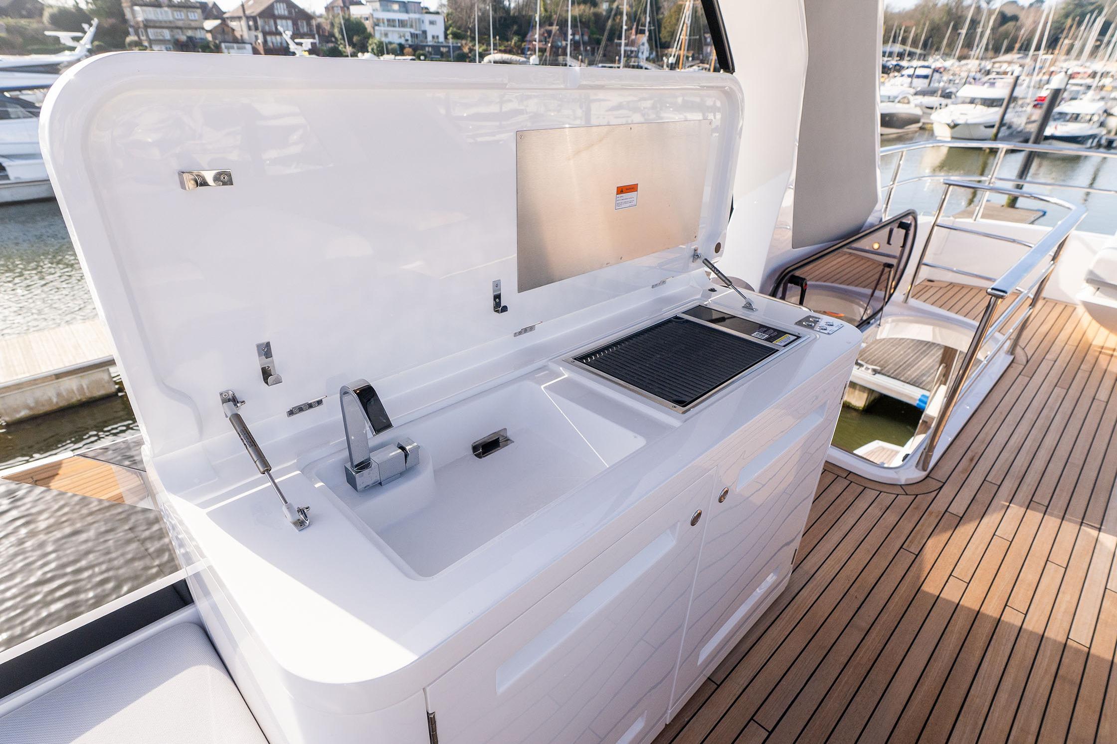 Outdoor kitchen on 2026 Sunseeker Manhattan 68 yacht, featuring sink and grill.