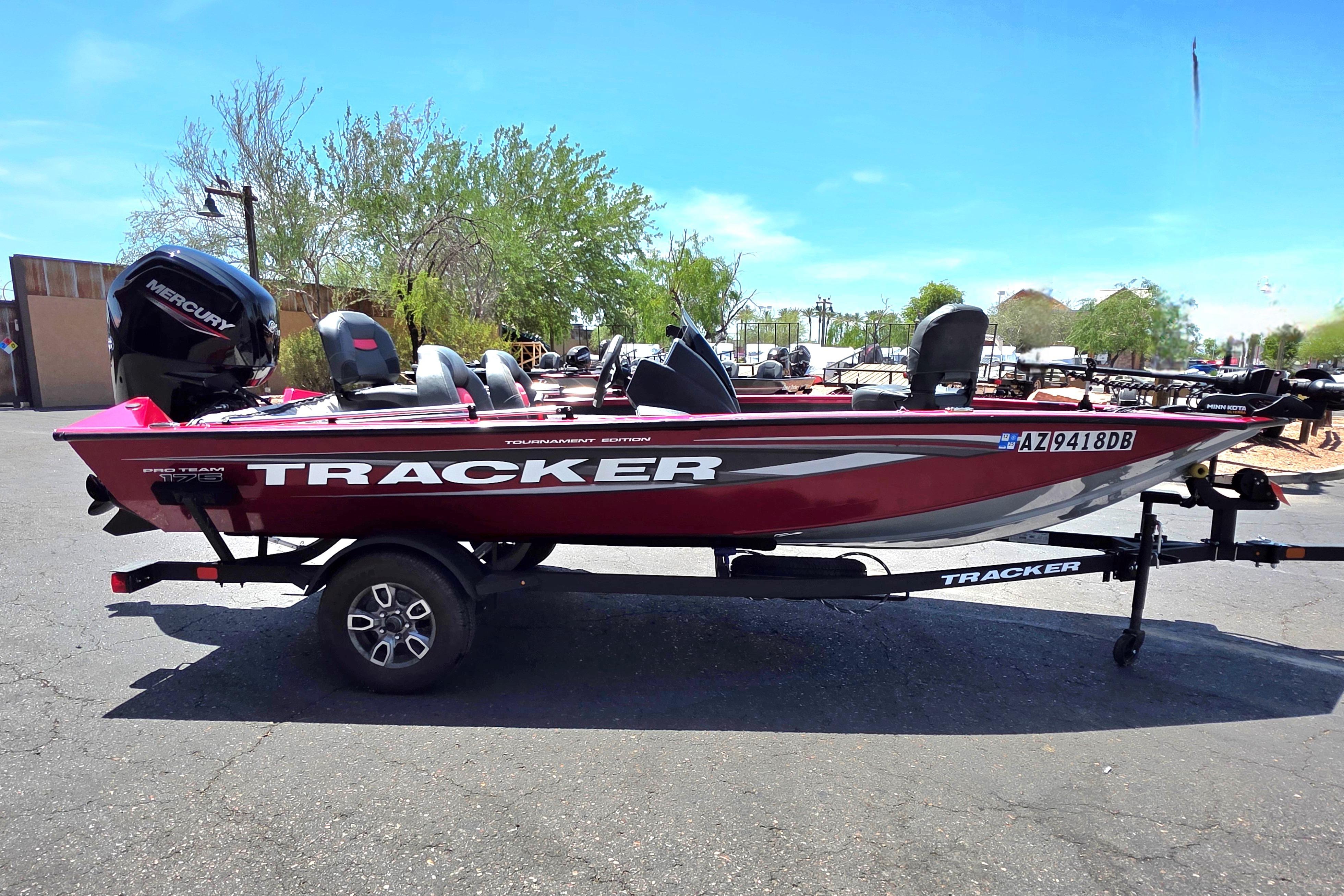 2025 Tracker Pro Team 175 boat on trailer, red color, parked outdoors.