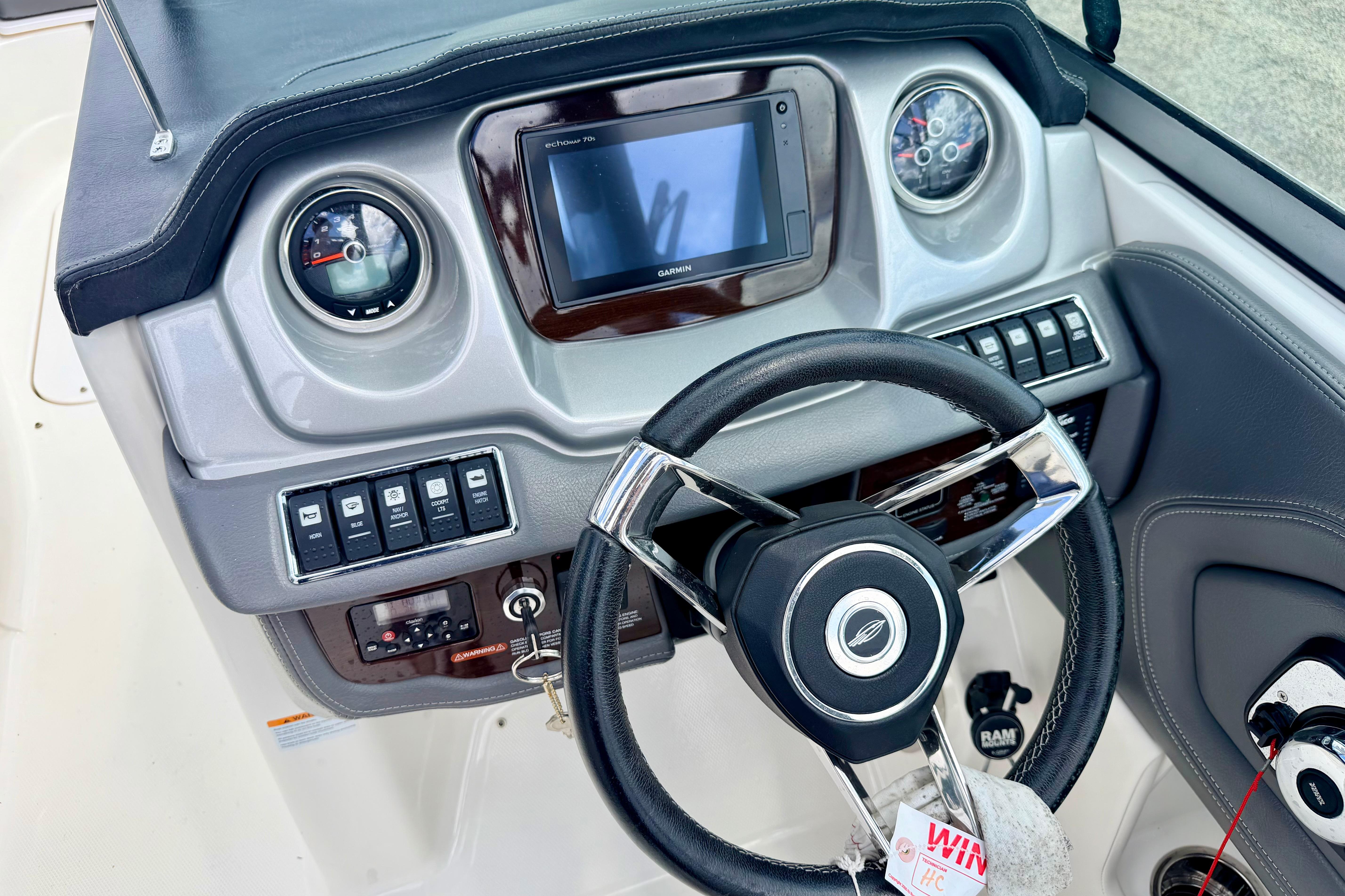 Dashboard of 2015 Chaparral Sunesta 264 boat with steering wheel and controls.