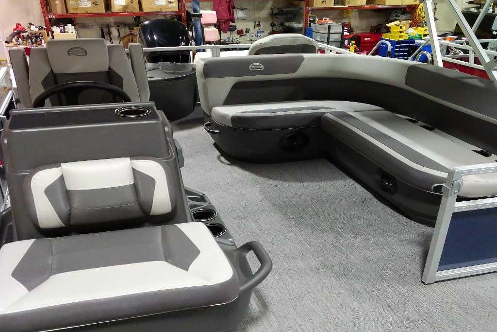 2026 Sun Tracker Bass Buggy 18 DLX interior with gray seating and steering console.