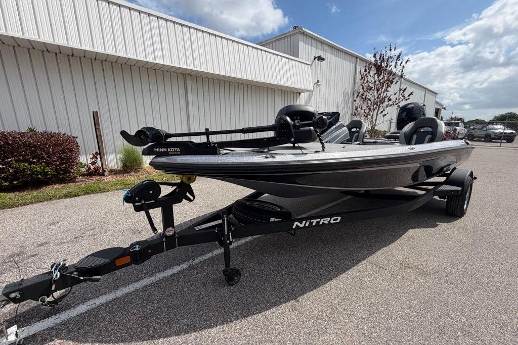 2026 Nitro Z18 boat on trailer, parked outdoors near a white building.