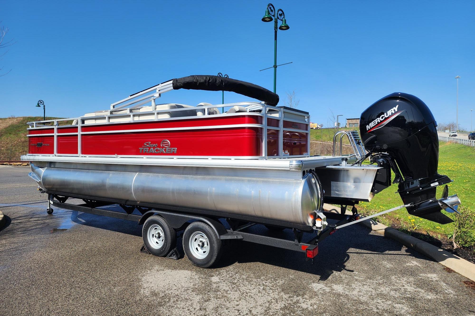 2026 Sun Tracker Fishin' Barge 22 DLX pontoon boat with Mercury engine on trailer.