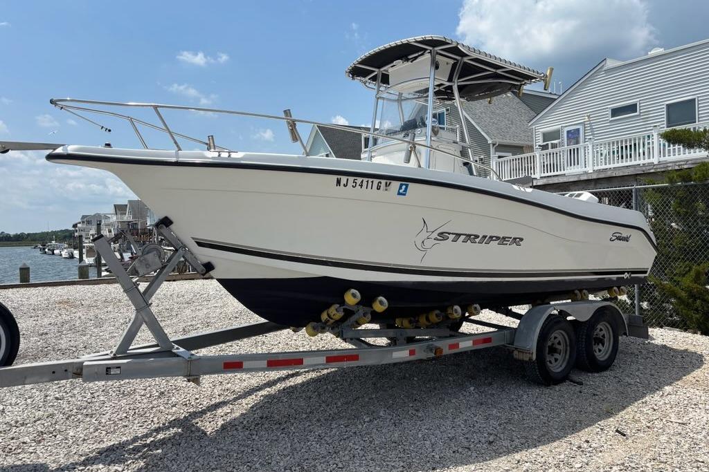 2002 Seaswirl Striper 2101 Center Console boat on trailer, dockside view.
