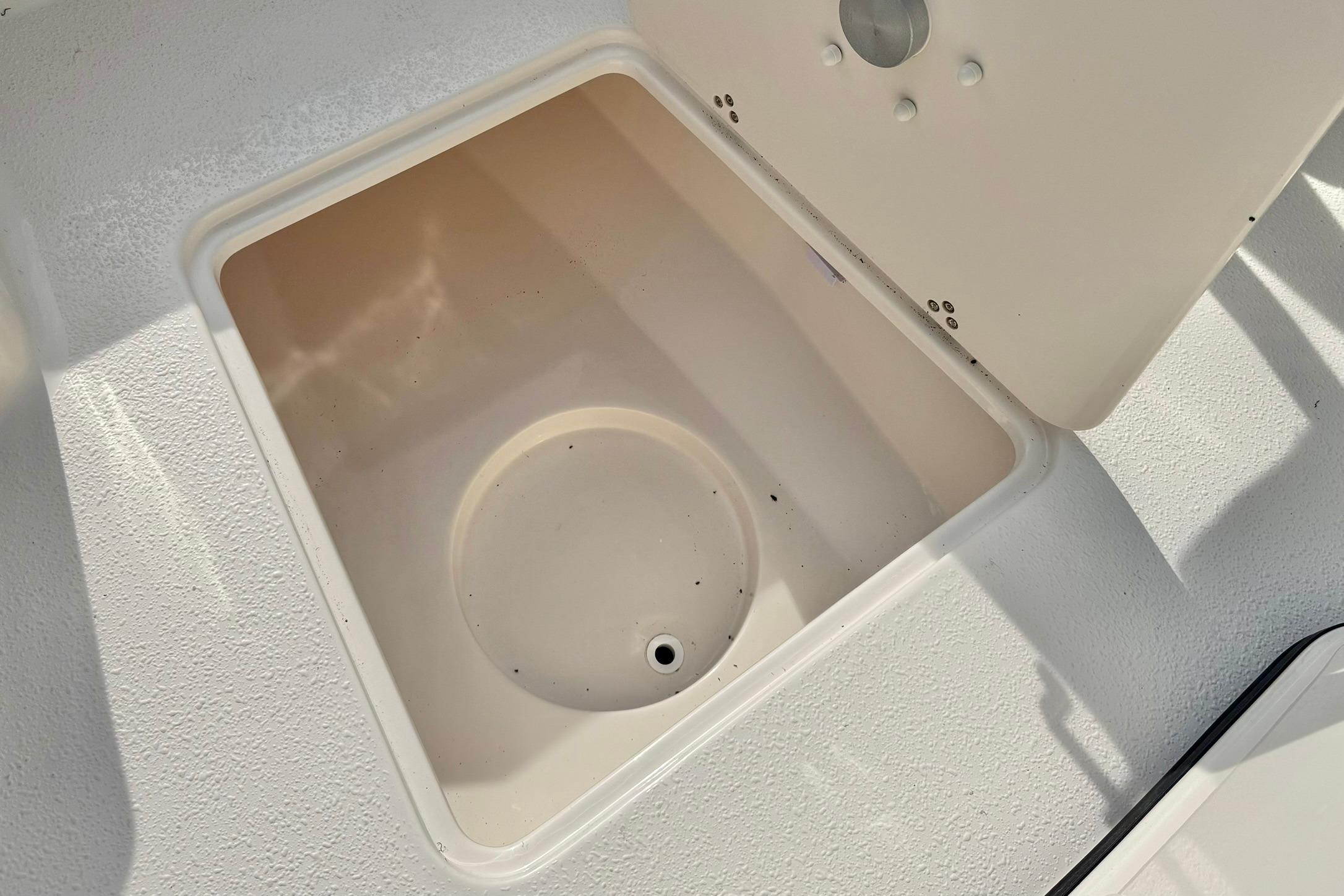 Open storage compartment on 2026 Carolina Skiff 24 Ultra Elite boat.