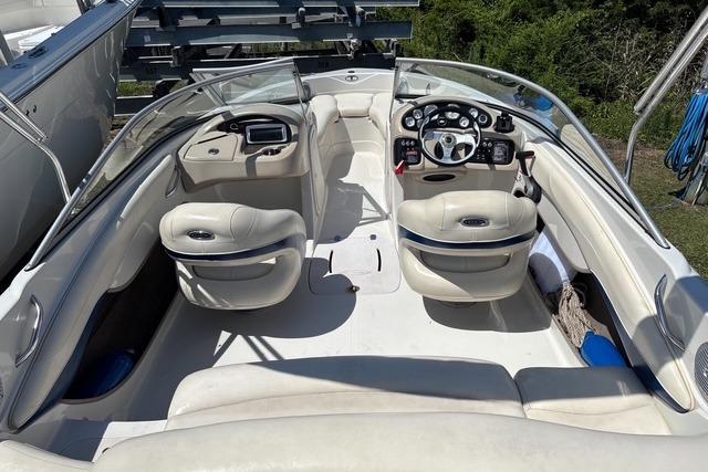 2012 Tahoe Q8 SSi boat interior with white seating and control panel.