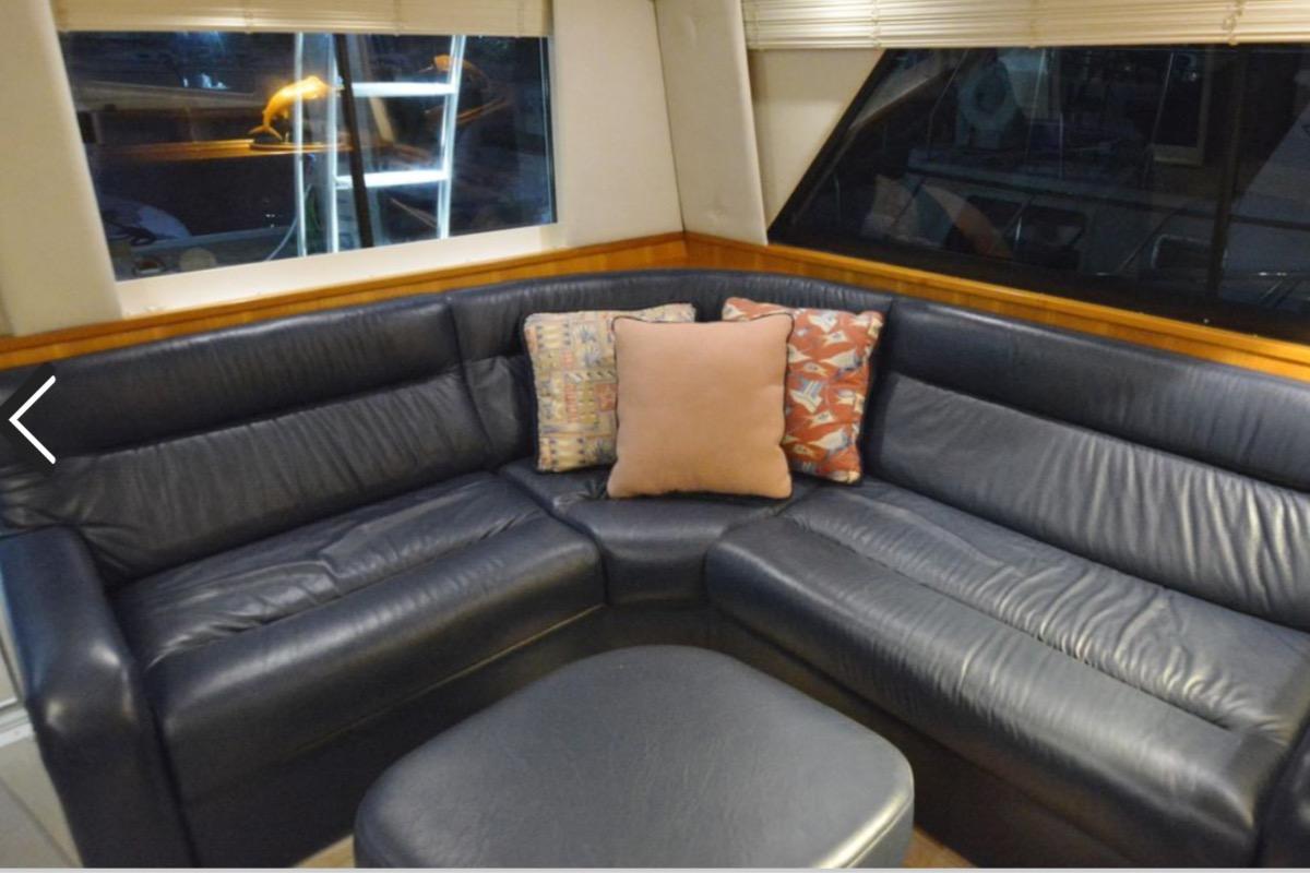 Luxurious leather seating in 2000 Riviera 48 Enclosed Flybridge yacht interior.