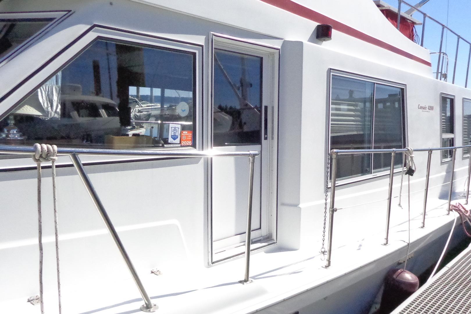 1992 Cruise-A-Home Corsair 4200 boat docked, featuring sleek windows and railing.