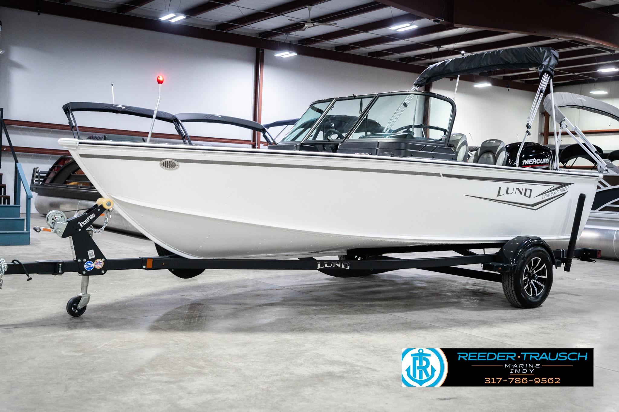 2026 Lund 1700 Explorer Sport boat on trailer in indoor showroom.