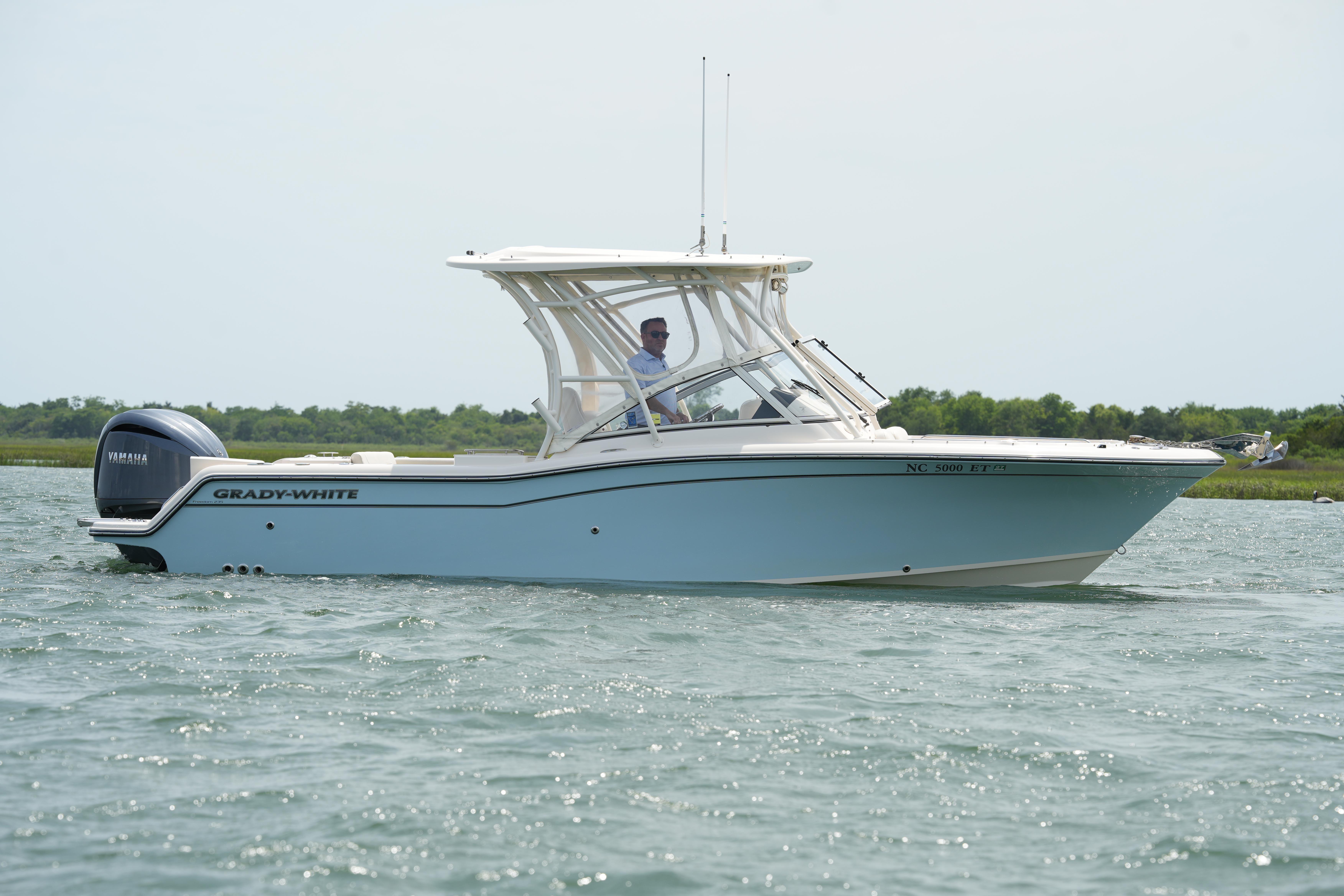 2021 Grady-White Freedom 235 boat cruising on calm waters.