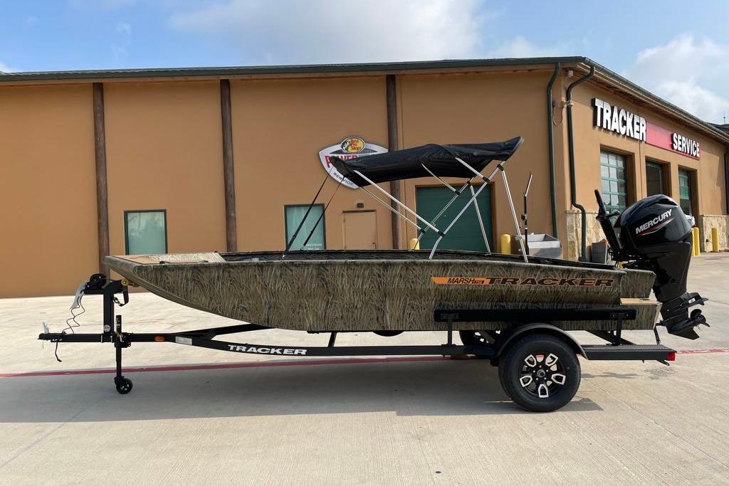 2026 Tracker Grizzly 1756 T Marsh boat with canopy, parked outside Tracker service center.